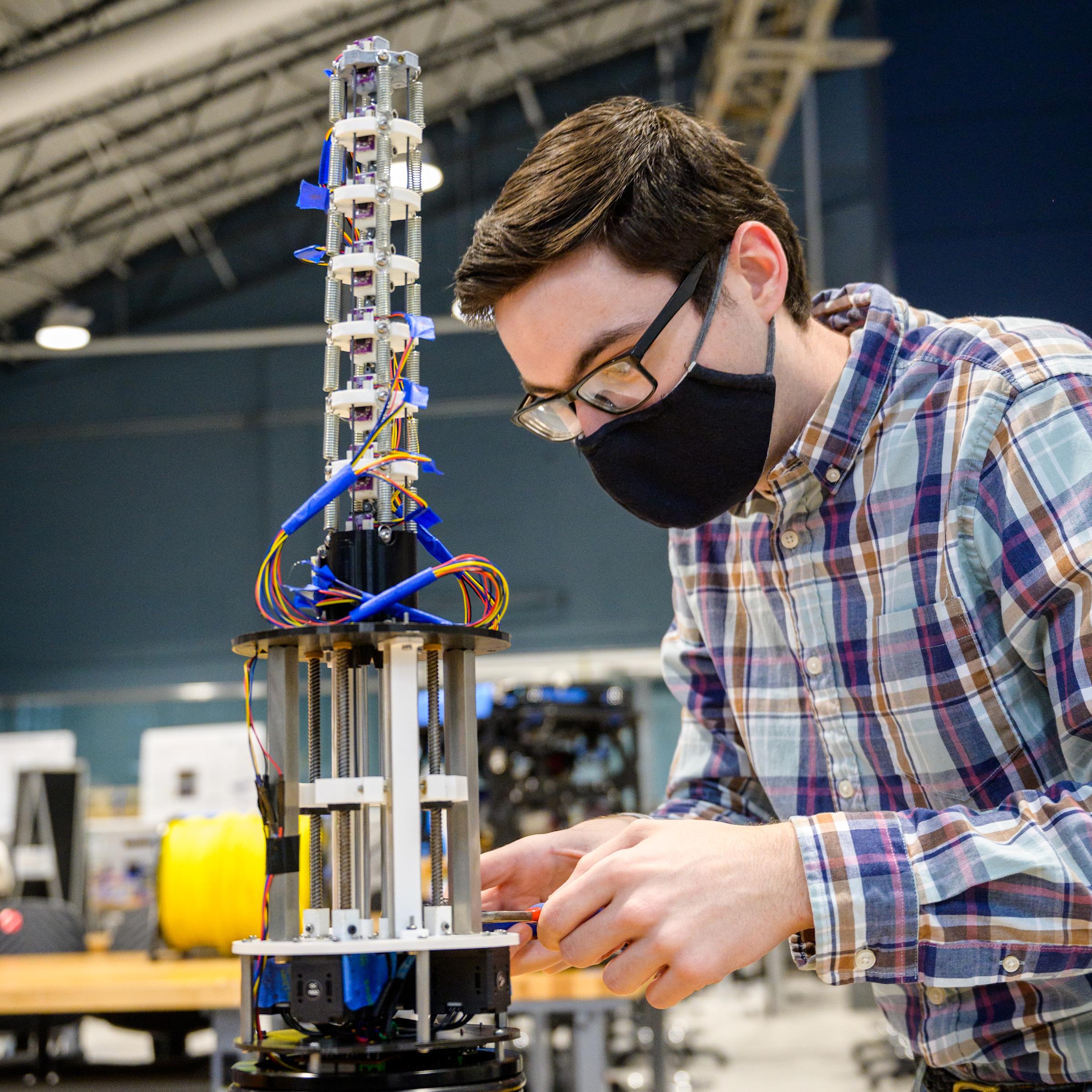 student working on robotics project in lab