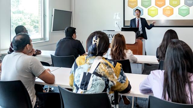 Students in class listening to a lecture.