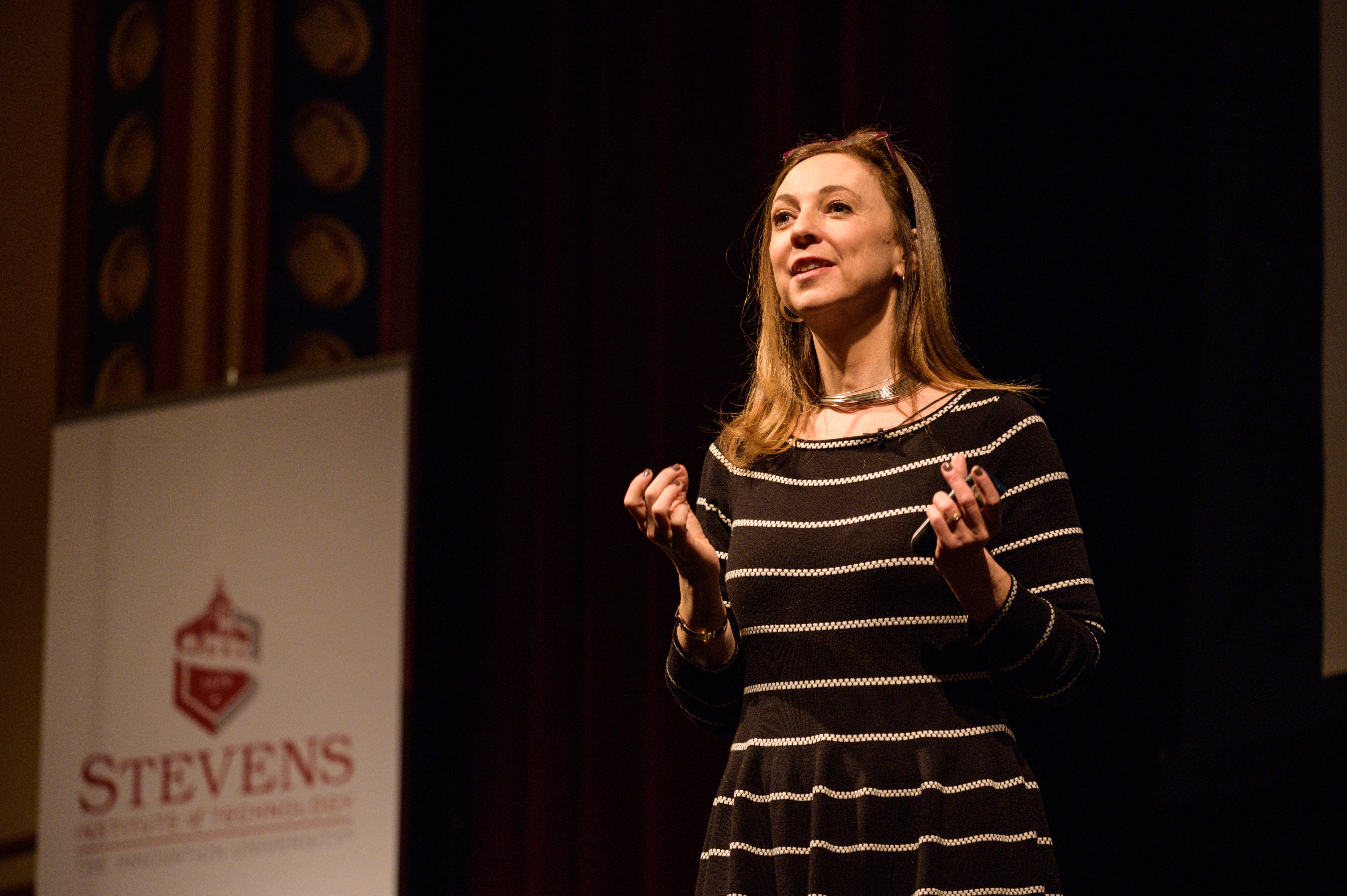 Susan Cain on stage facing an audience in DeBaun Auditorium at Stevens Institute of Technology