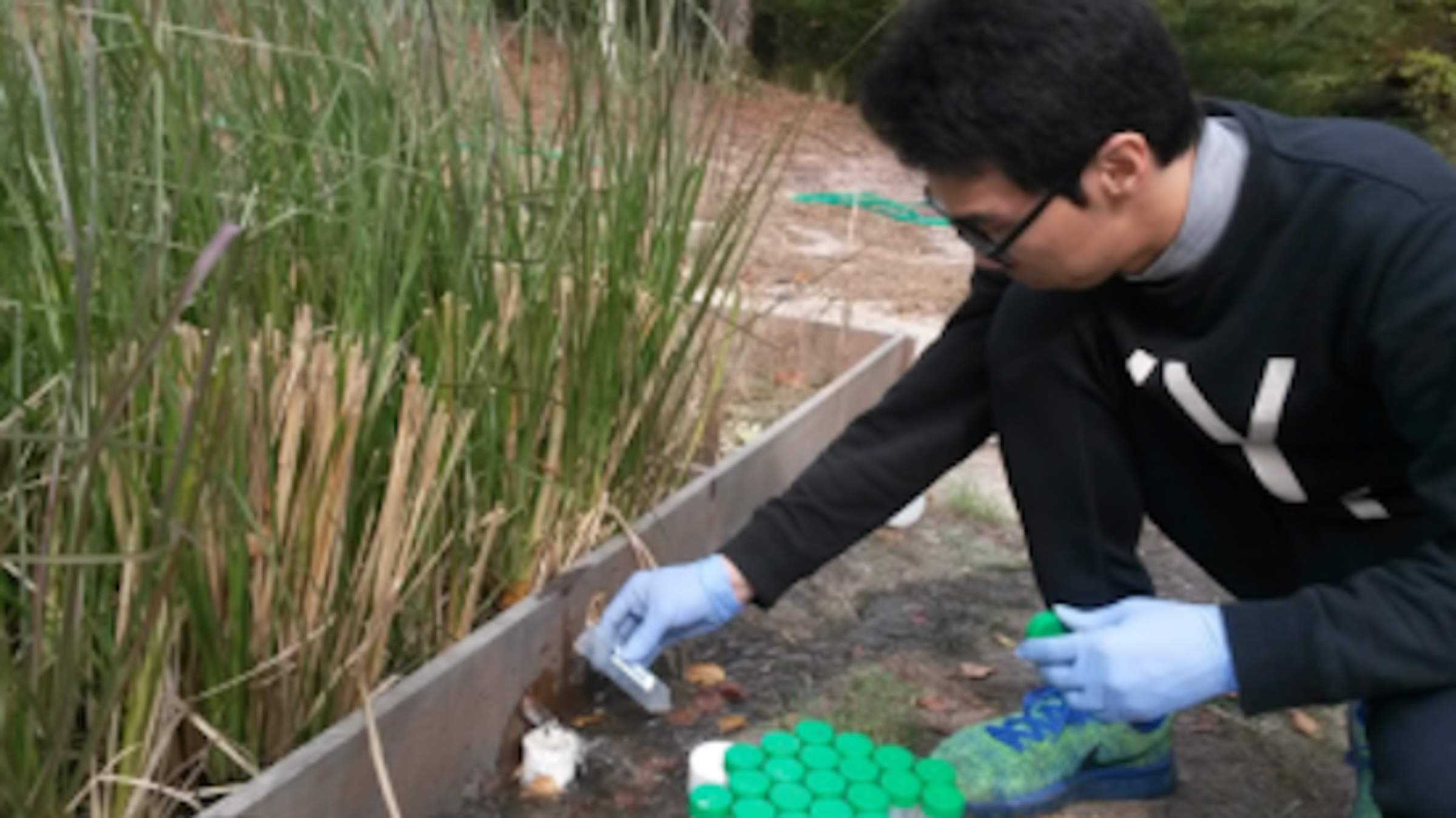 environmental research student testing soil
