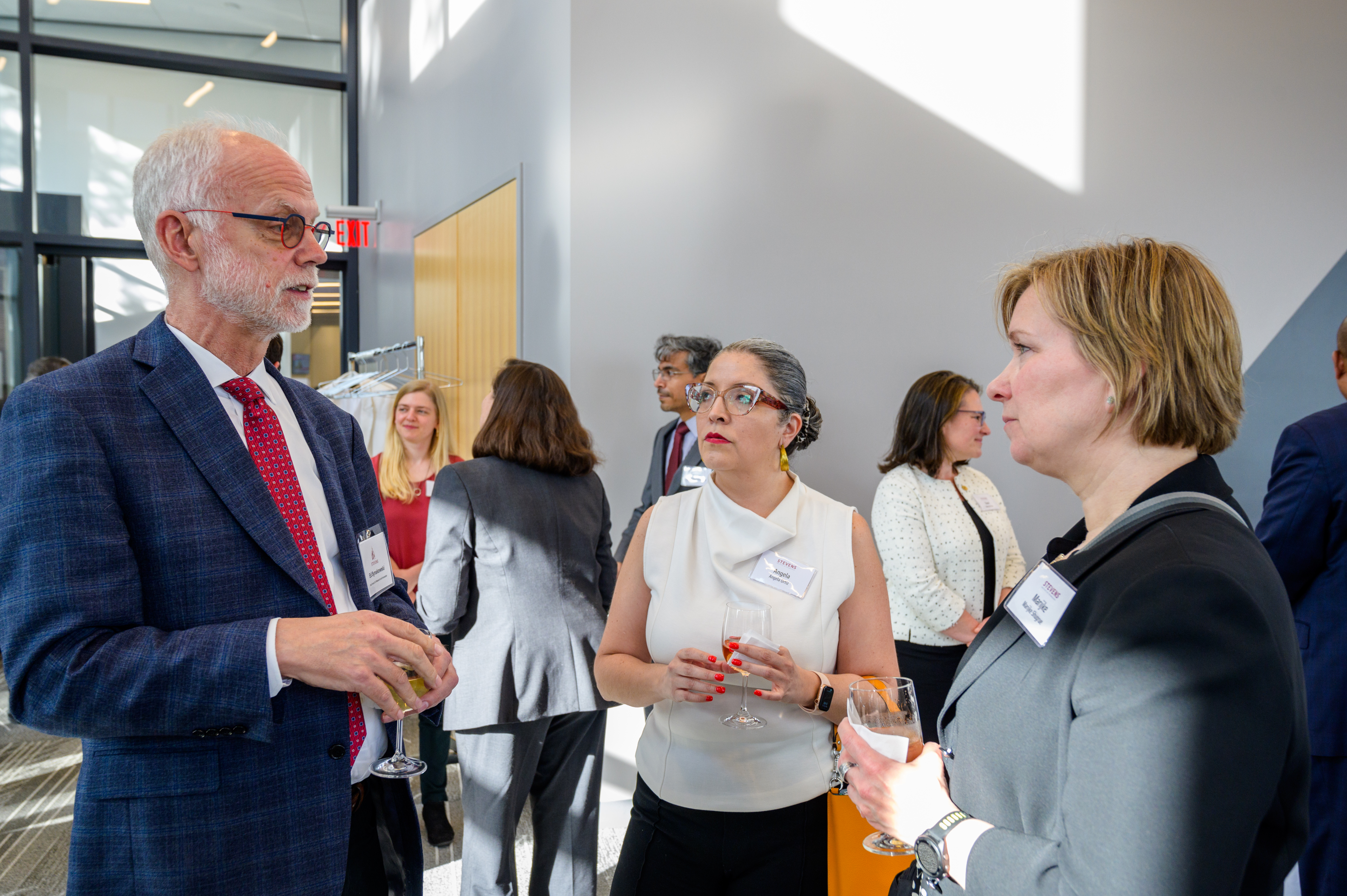 Two alums connect with Vice Provost Ed Synakowski at a networking event