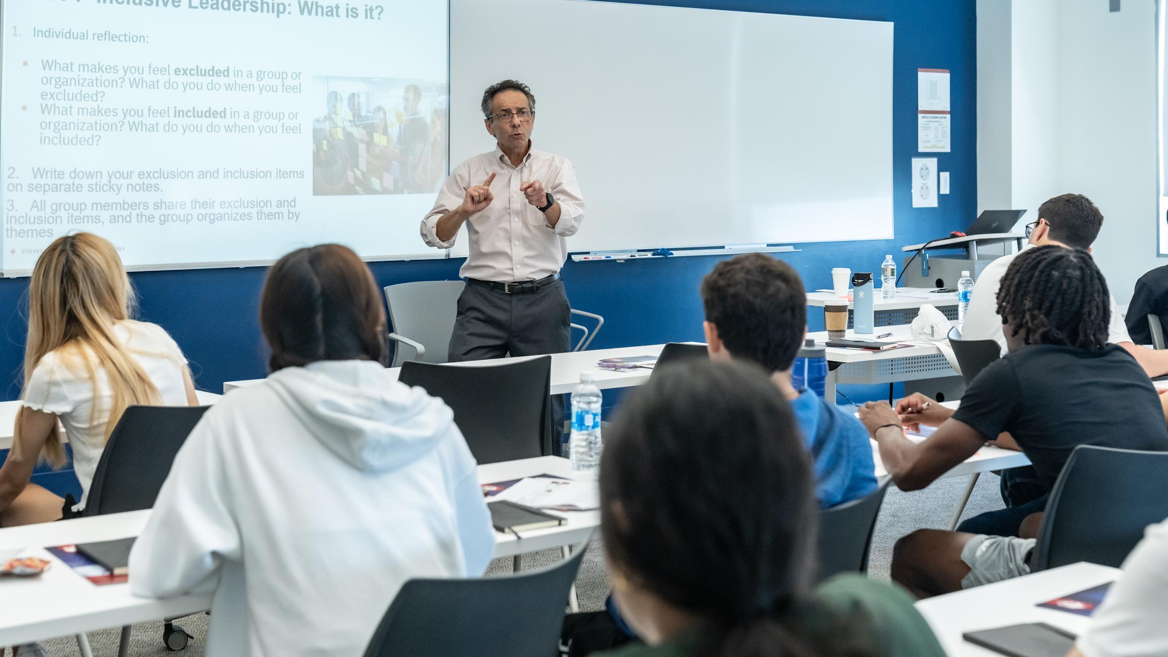 Professor Dominick speaking to a group of students