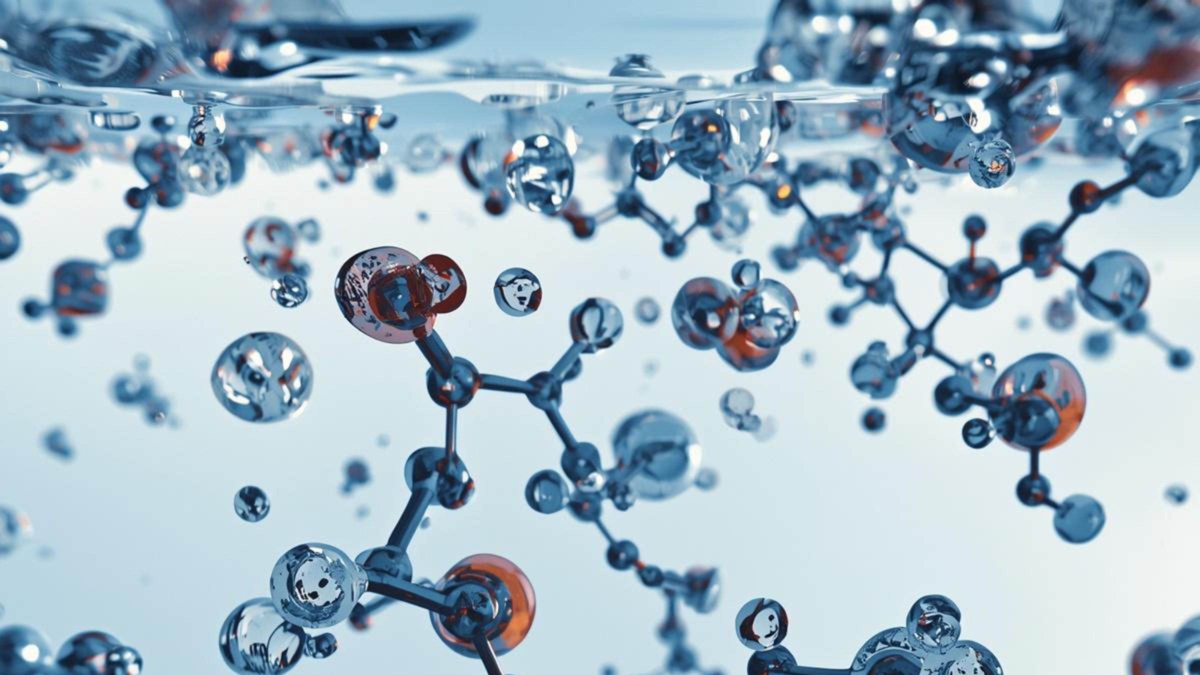 Abstract molecular structures with transparent spheres and connecting rods submerged in liquid, with bubbles visible near the surface.