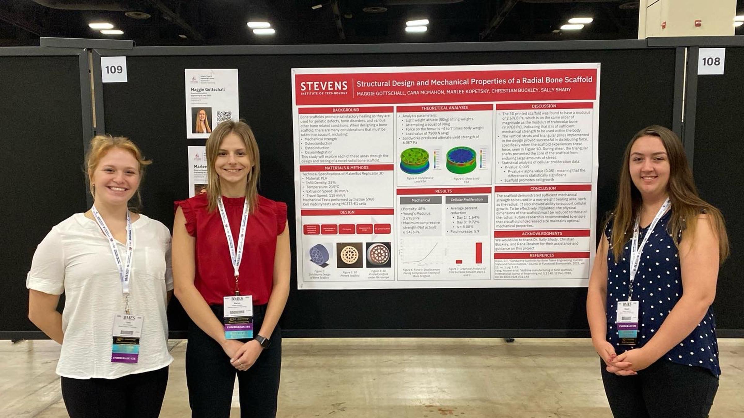 Cara McMahon ‘24, Marlee Kopetsky ‘23 and Maggie Gottschall ‘23 stand next to their poster at the 2022 Biomedical Engineering Society Conference