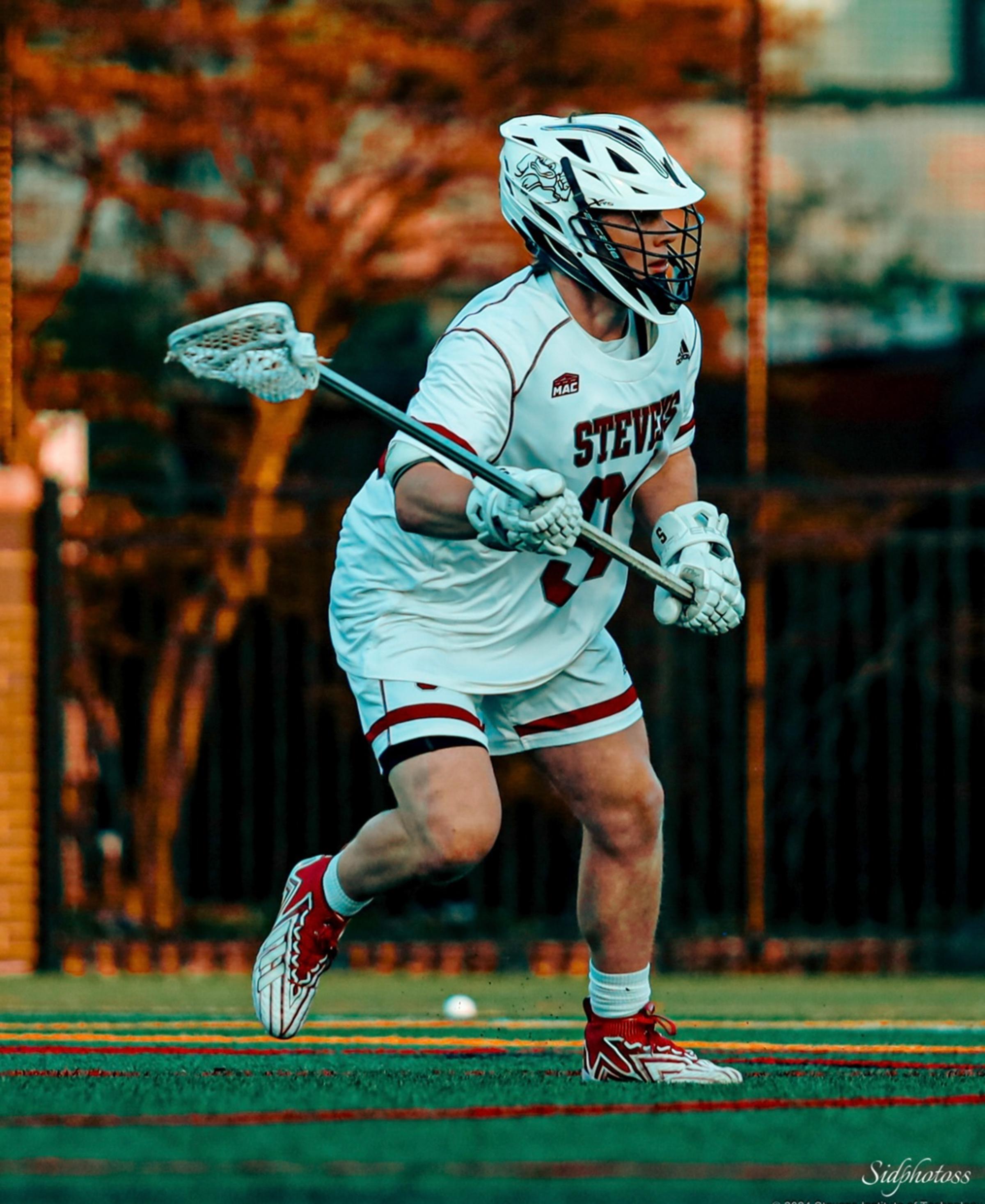 Luke Lesizza playing defense during a lacrosse game