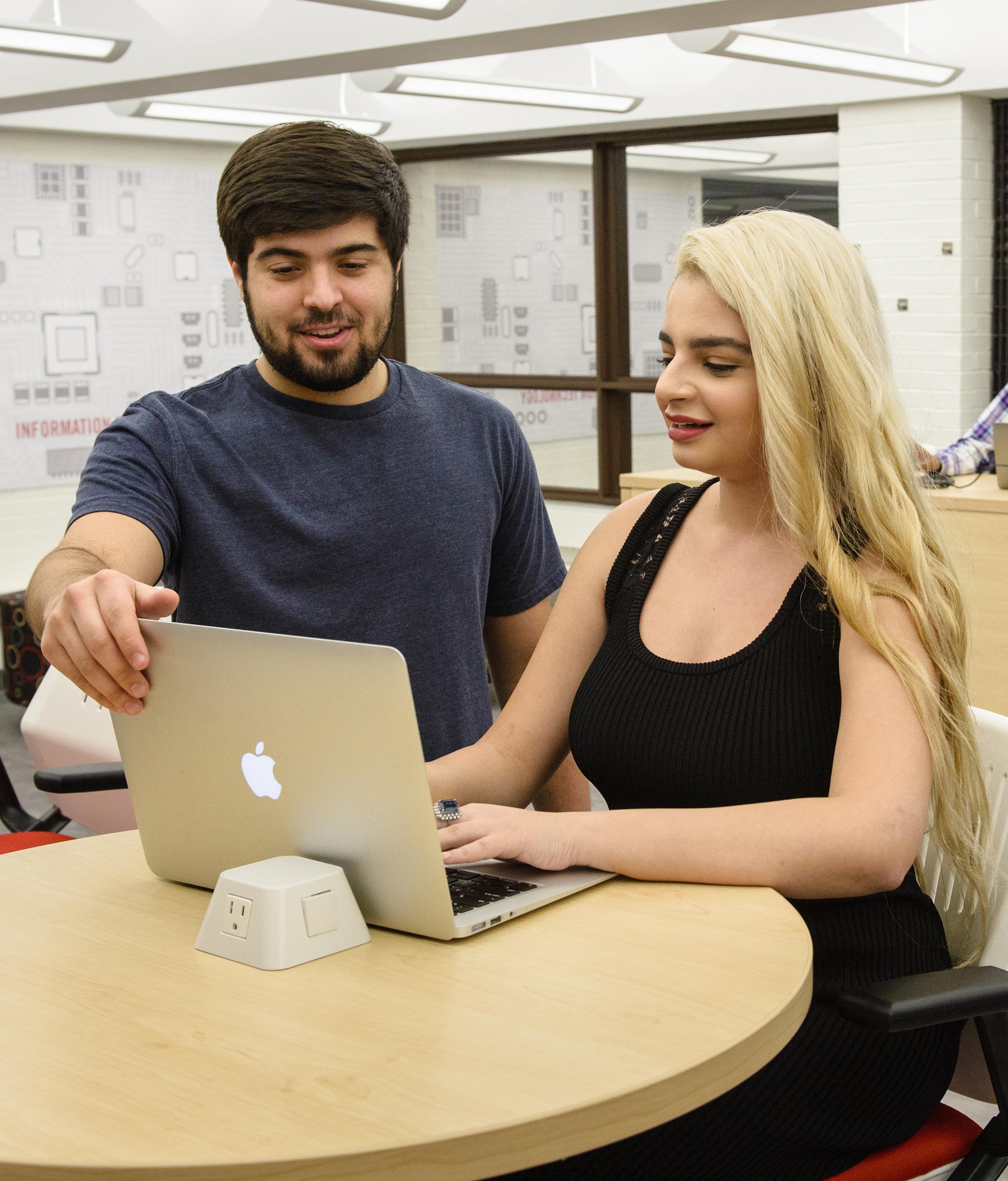 Two students at TRAC using their laptops.