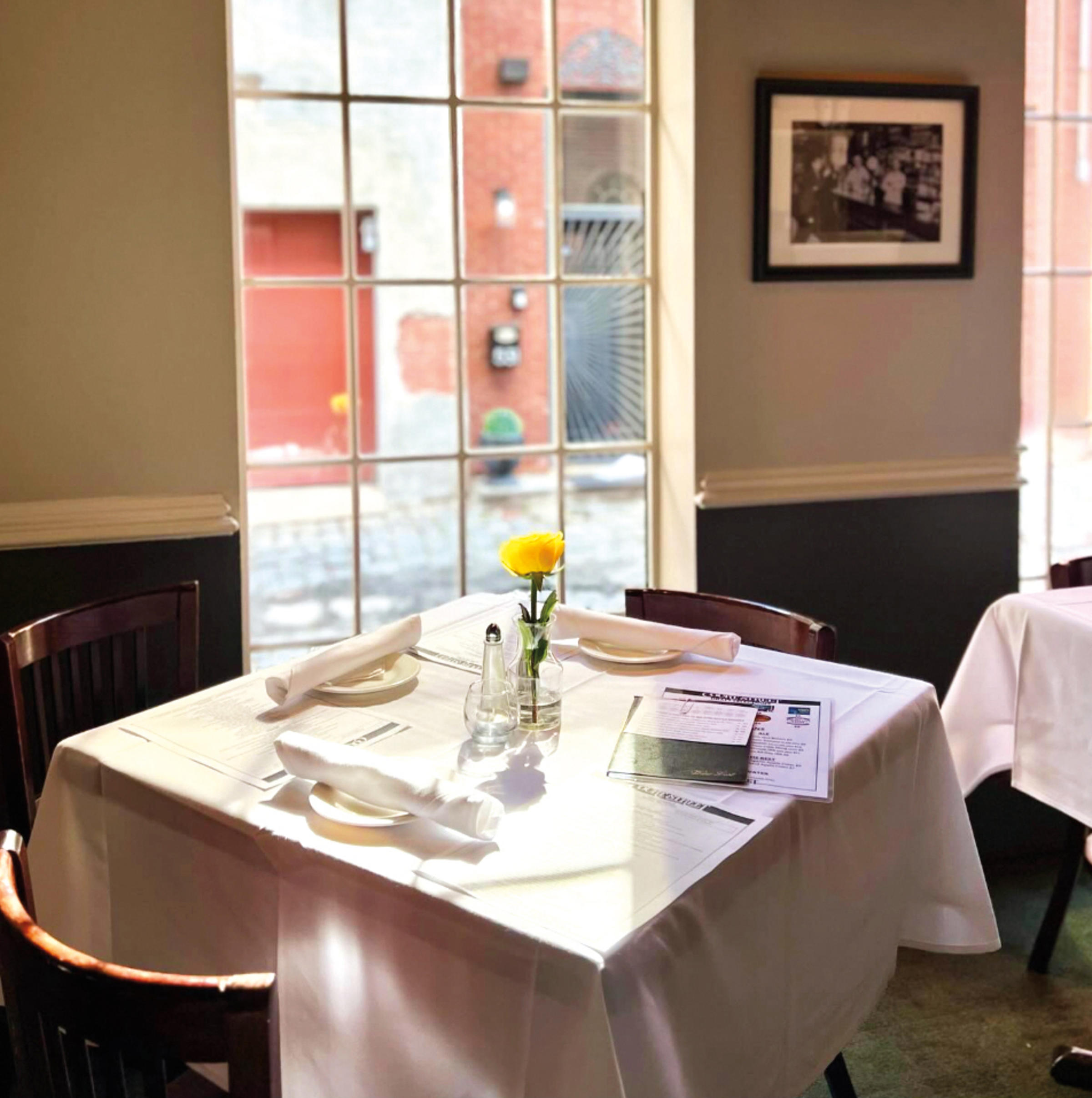 small dinner table, near a window, inside Court Street restaurant.