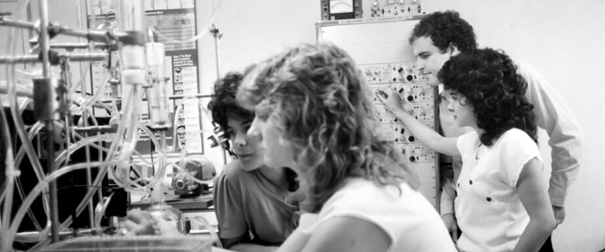 Black and white image of students working in a lab in the 1980s.