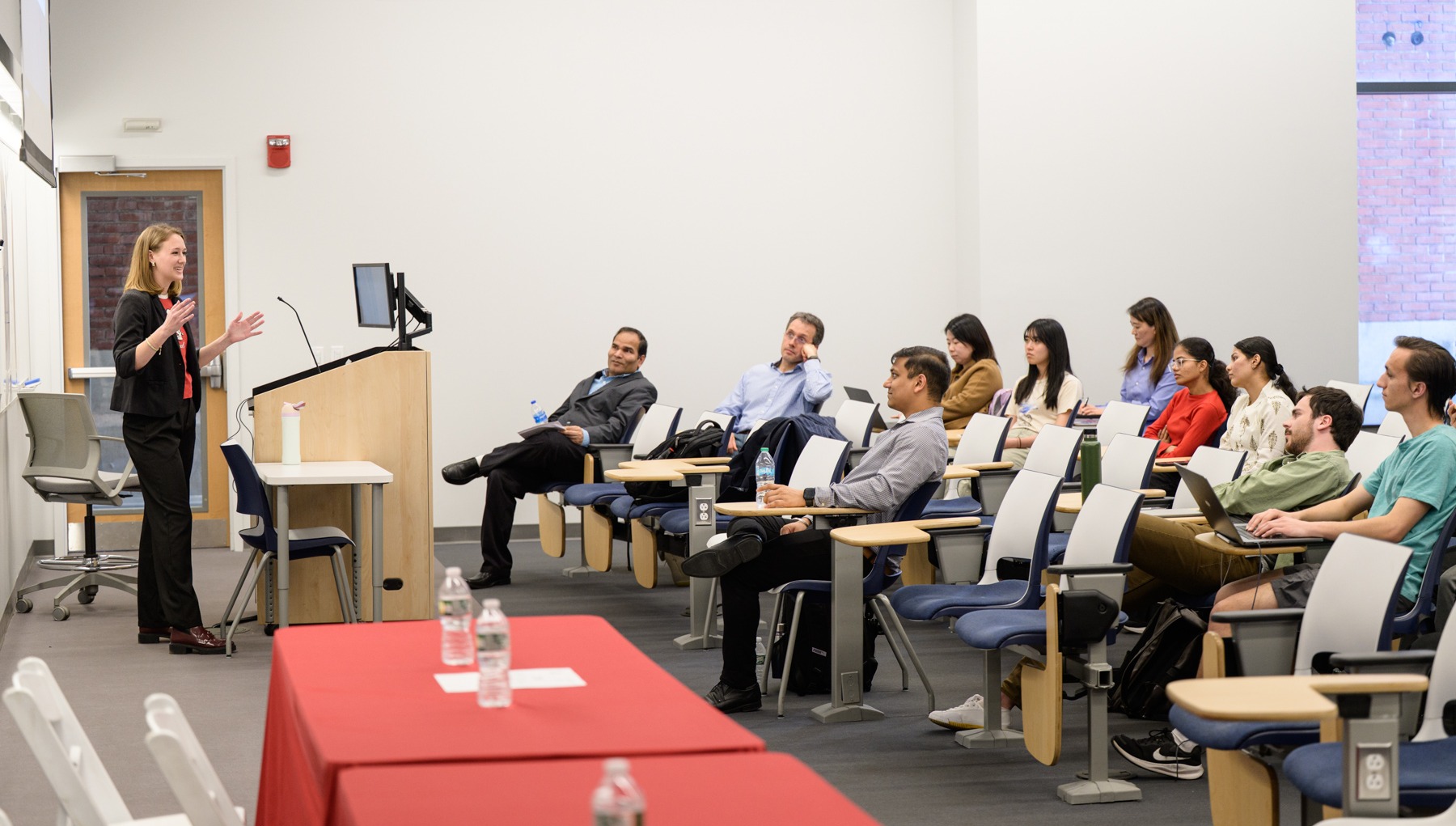 A full classroom of students listening intently to a lecture.