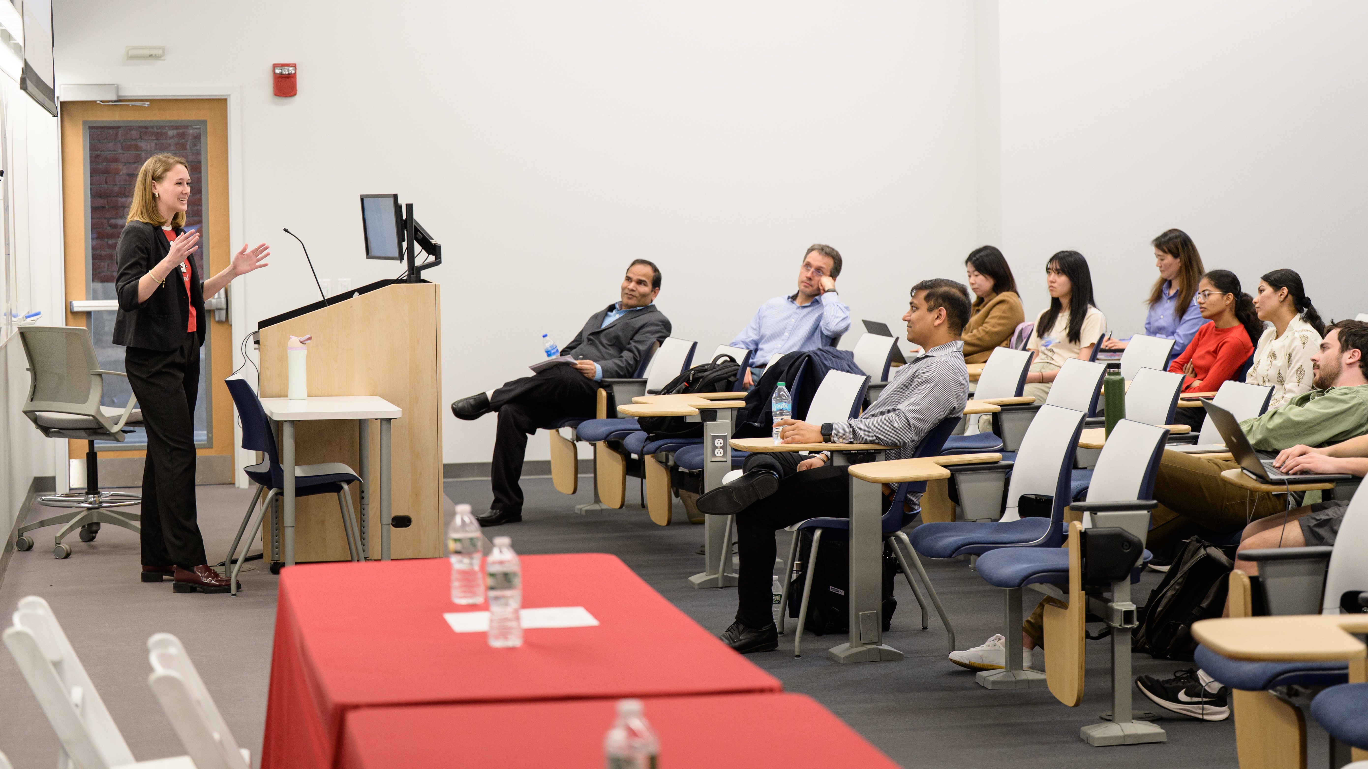 A full classroom of students listening intently to a lecture.