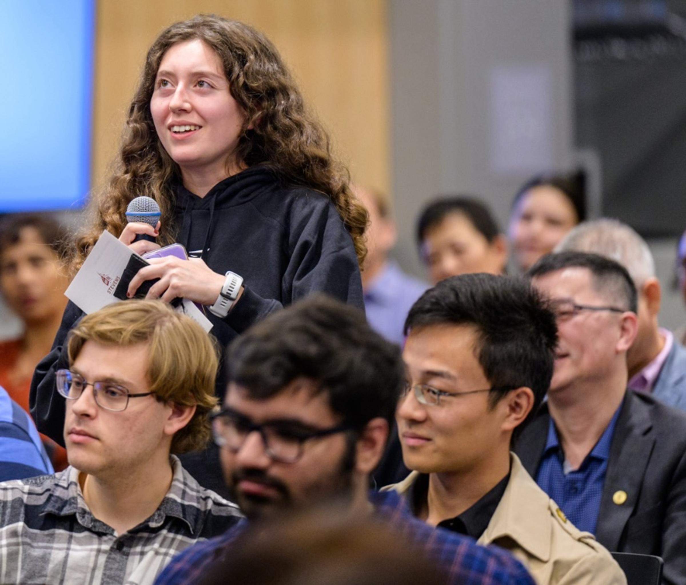 Student asking question in crowd at Fall 2024 Stevens event