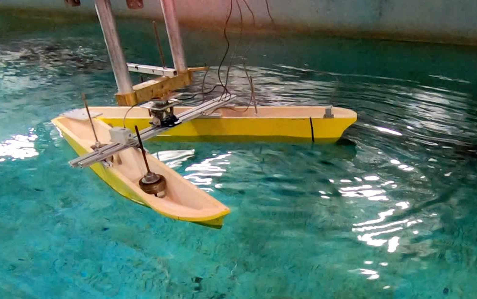 Prototype boat with its hull split into a "V" shape in Stevens' Davidson Lab wave tank