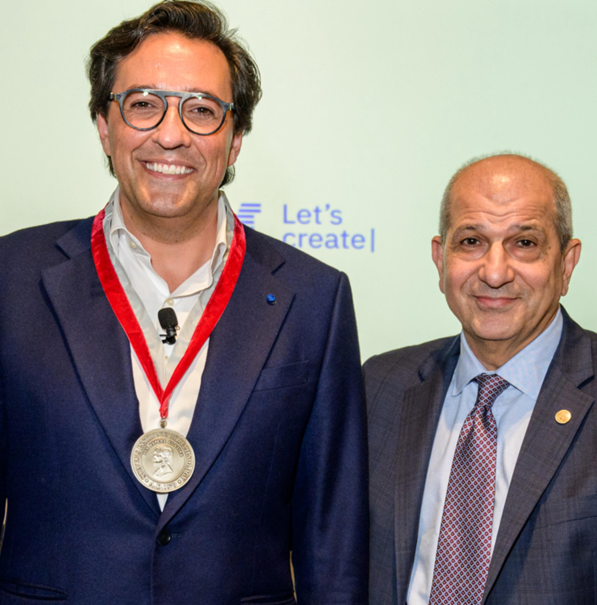 IBM guest lecturer Dario Gil, wearing a medal around his neck, and Stevens President Nariman Farvardin