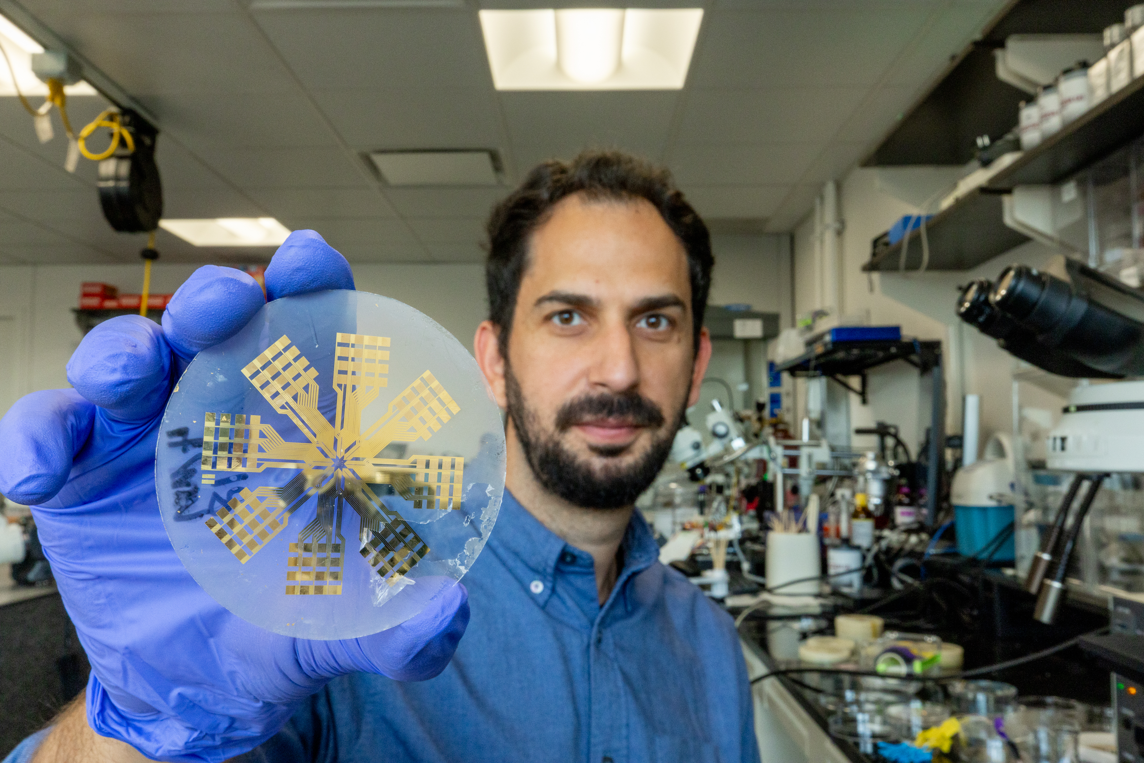 Ilke Uguz holds up a medical device. 