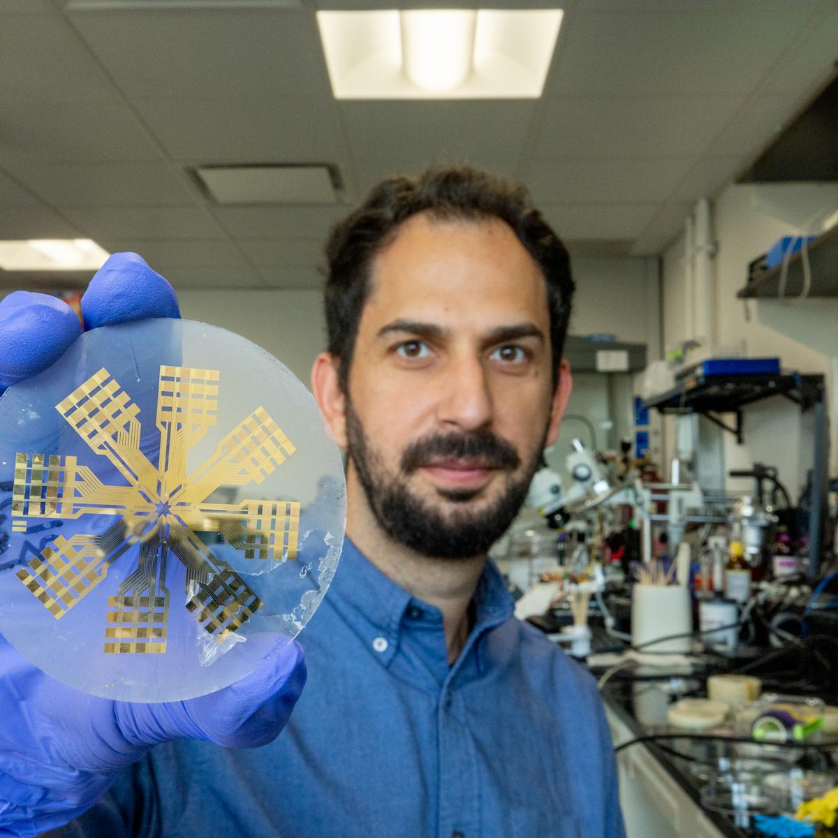 Ilke Uguz holds up a medical device.