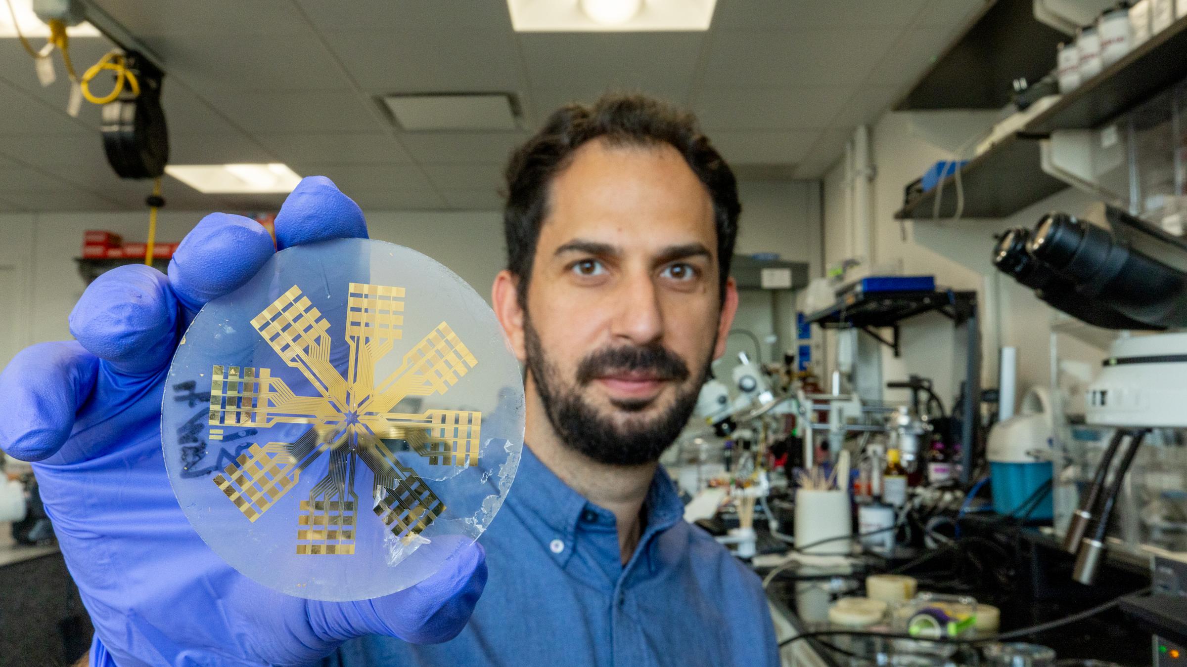 Ilke Uguz holds up a medical device.