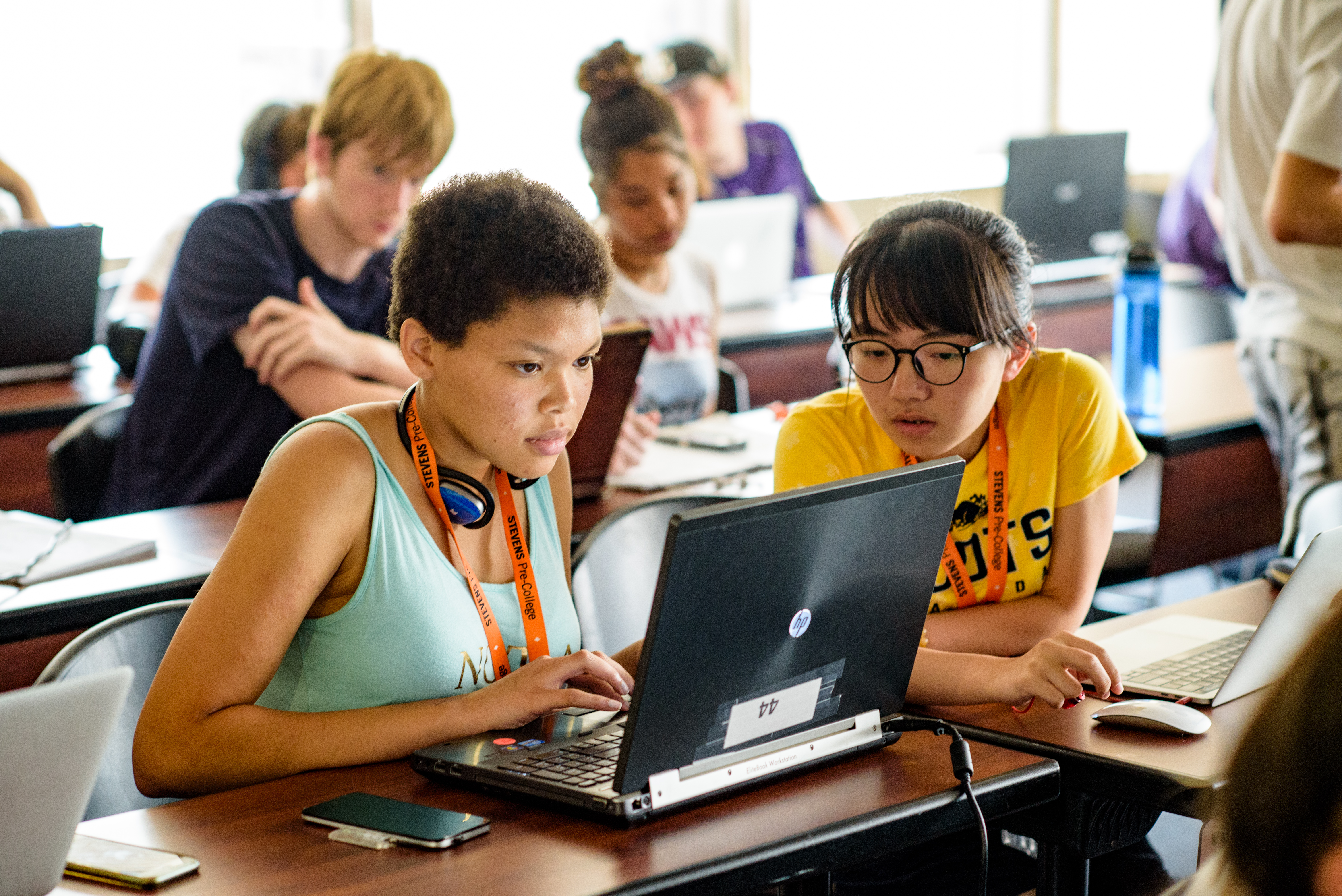Two high school students examine information on a laptop while visiting Stevens.