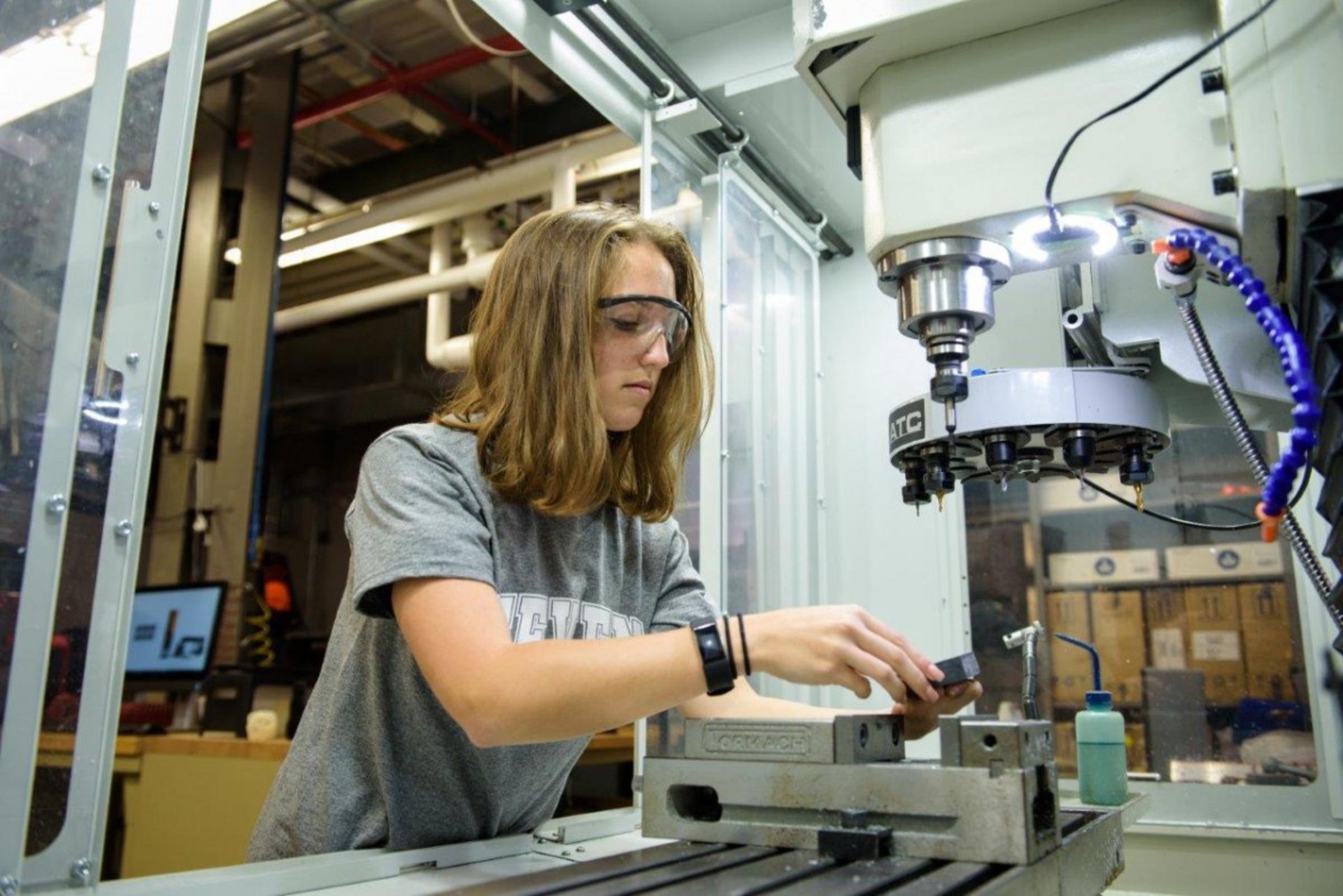 A woman building in machine shop