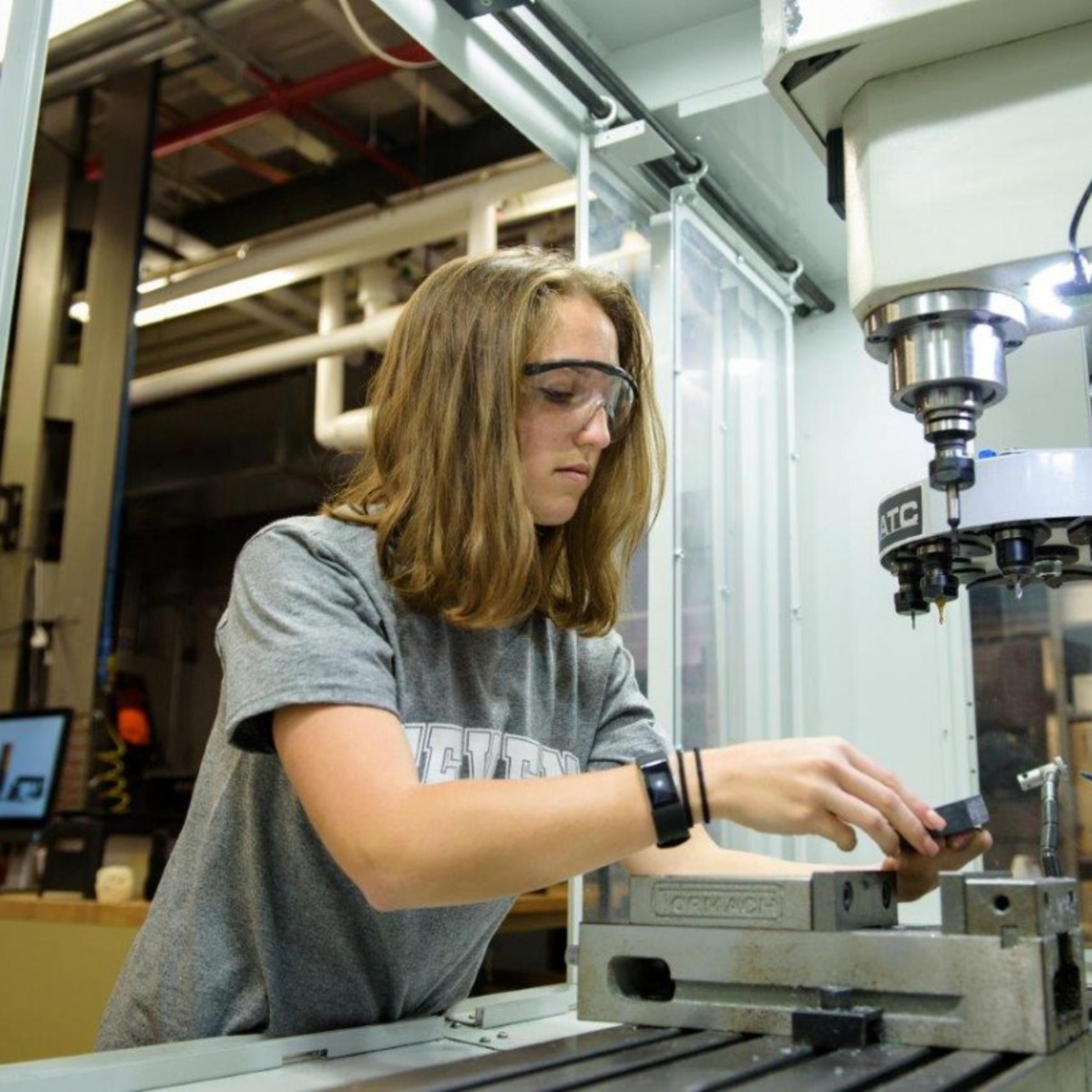 A woman building in machine shop