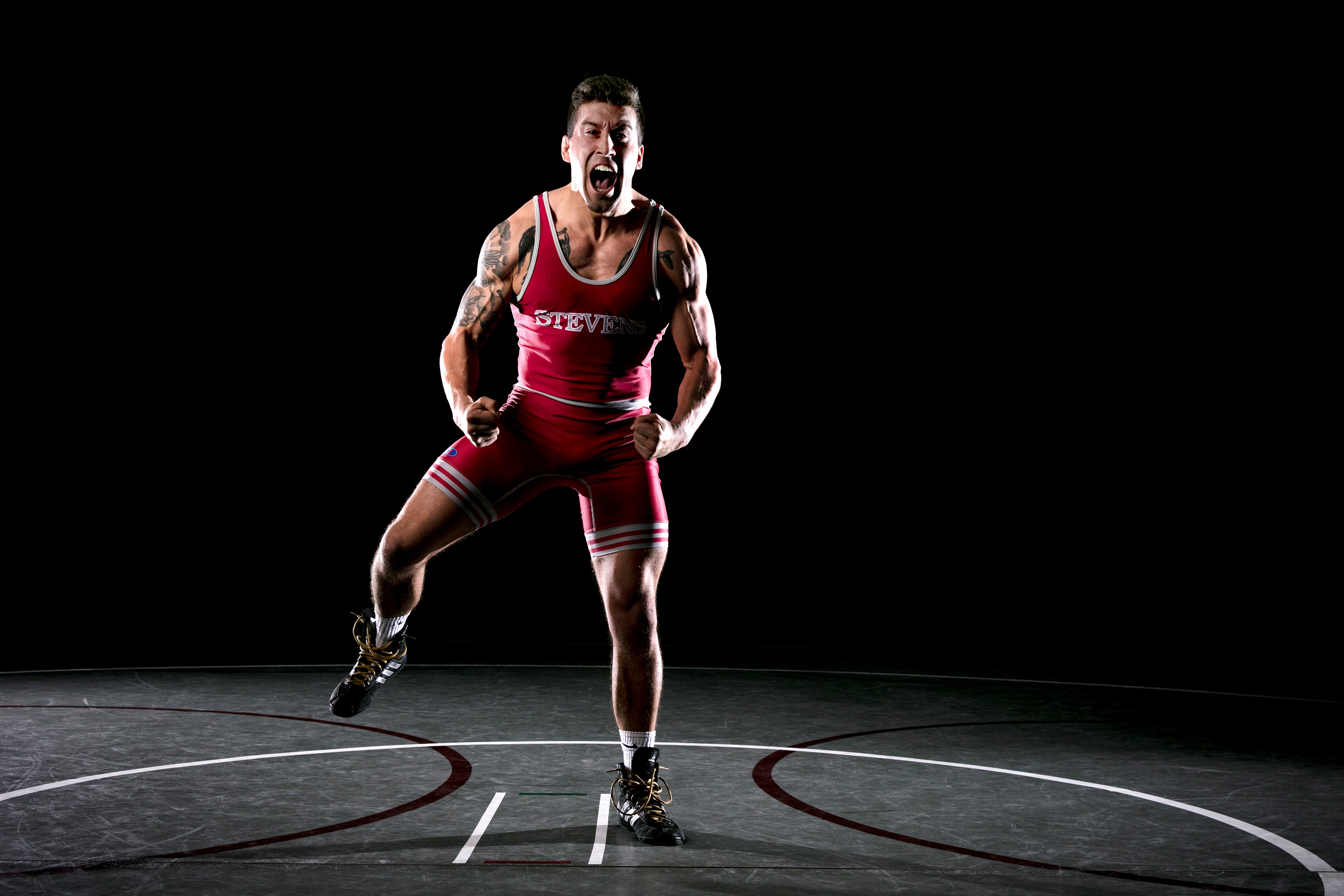 Photo of Dylan Van Sickell in wrestling singlet on a wrestling mat