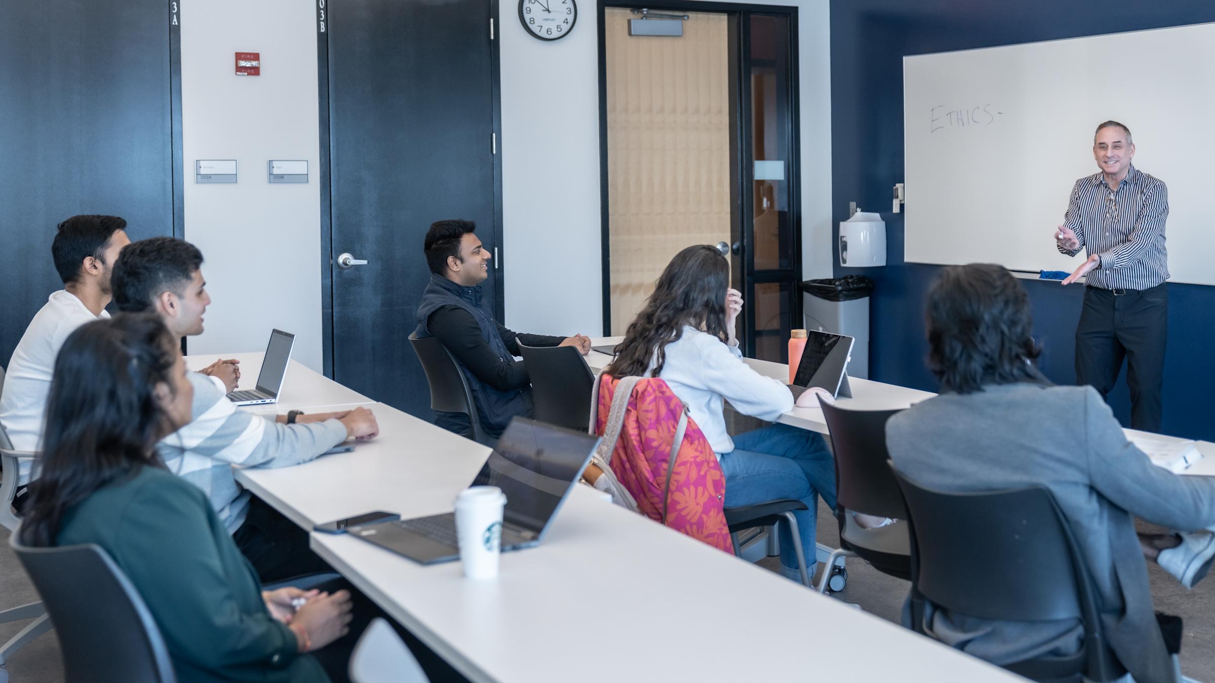 Professor Rothschild teaching students in a classroom