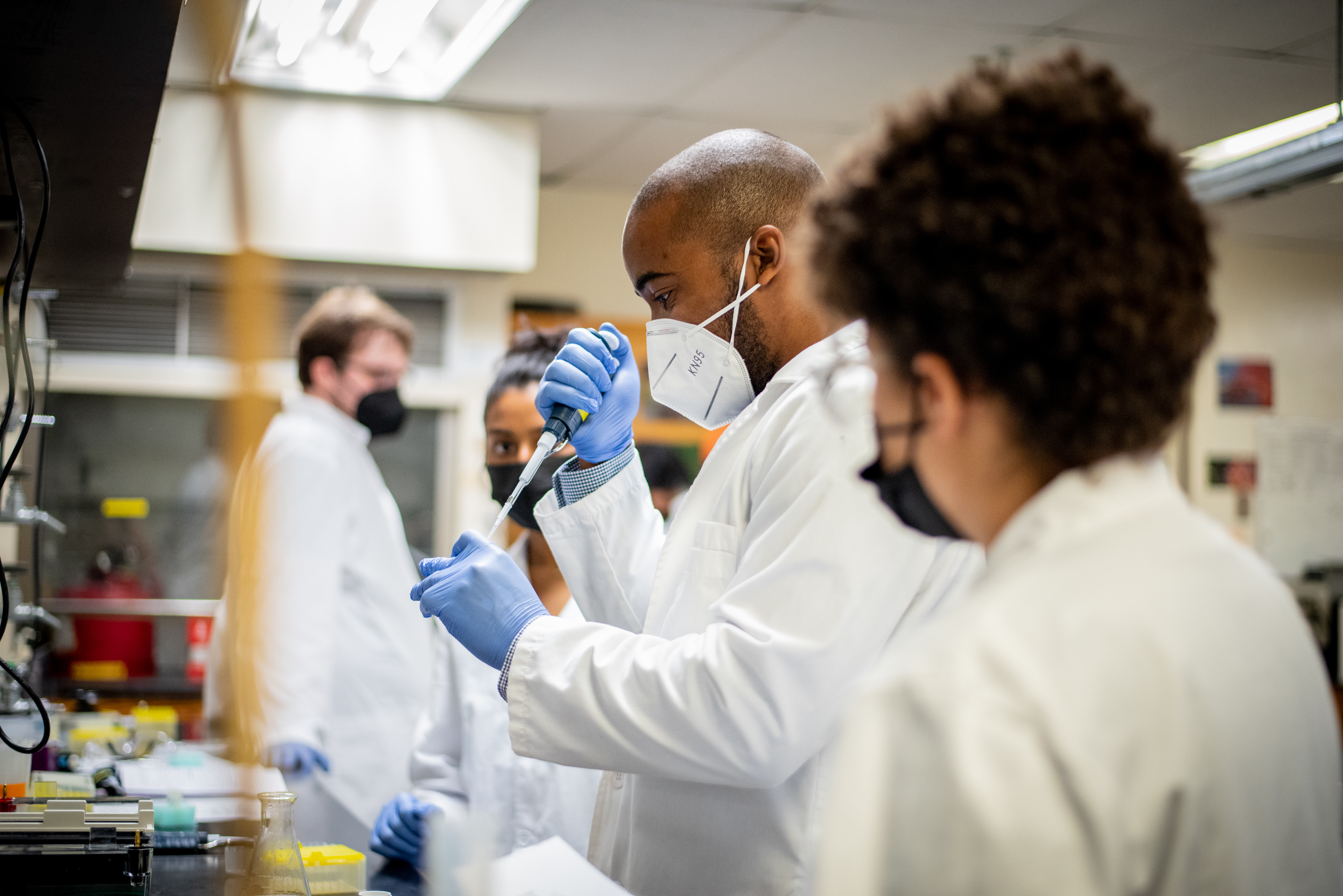 Students and instructor working in chemistry lab