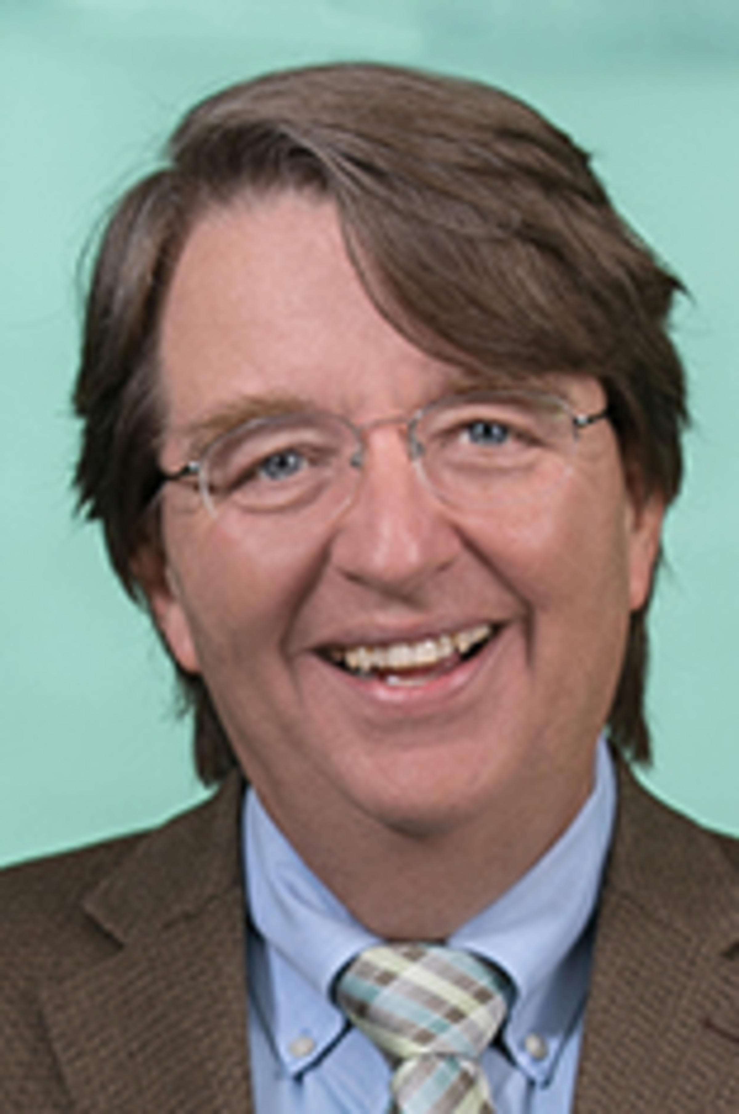 Headshot of Dr. Kevin Ryan with Manhattan in the background.