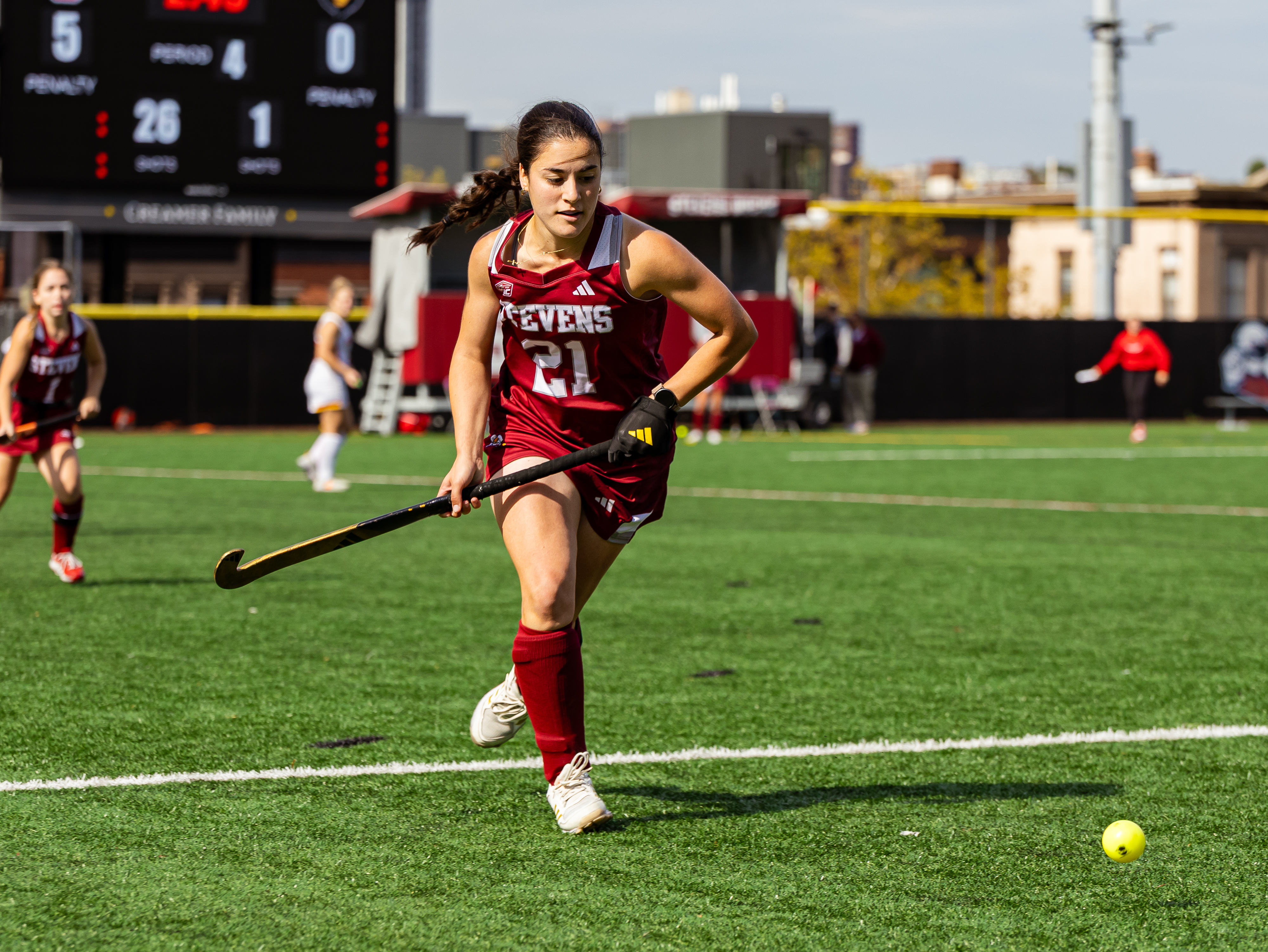 Emilia Lopes runs on the field during a field hockey game