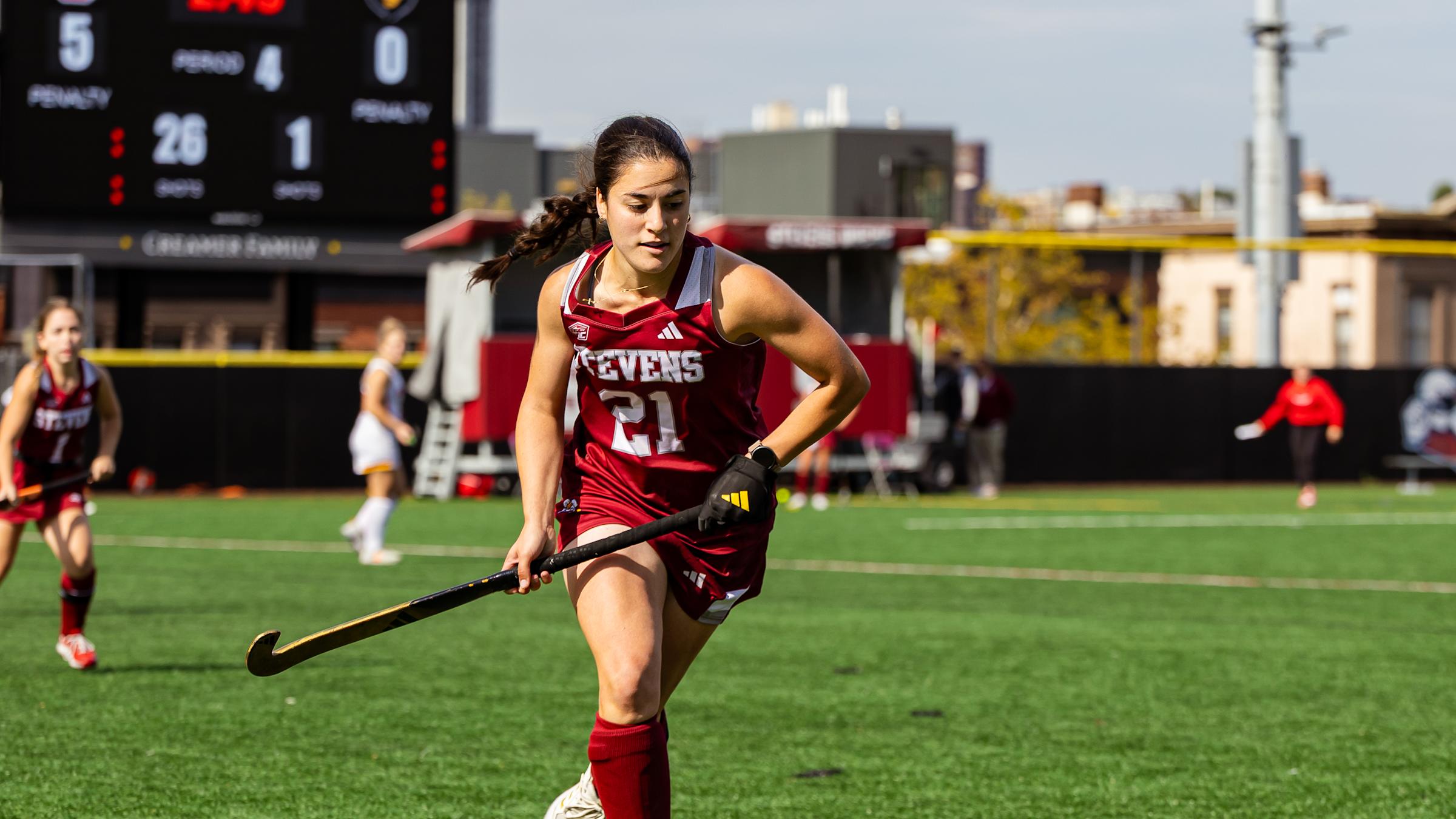 Emilia Lopes runs on the field during a field hockey game