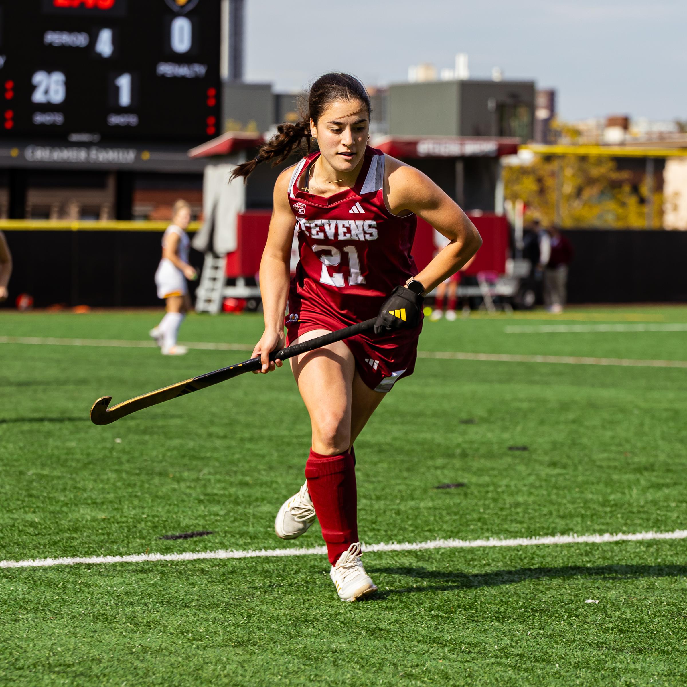Emilia Lopes runs on the field during a field hockey game