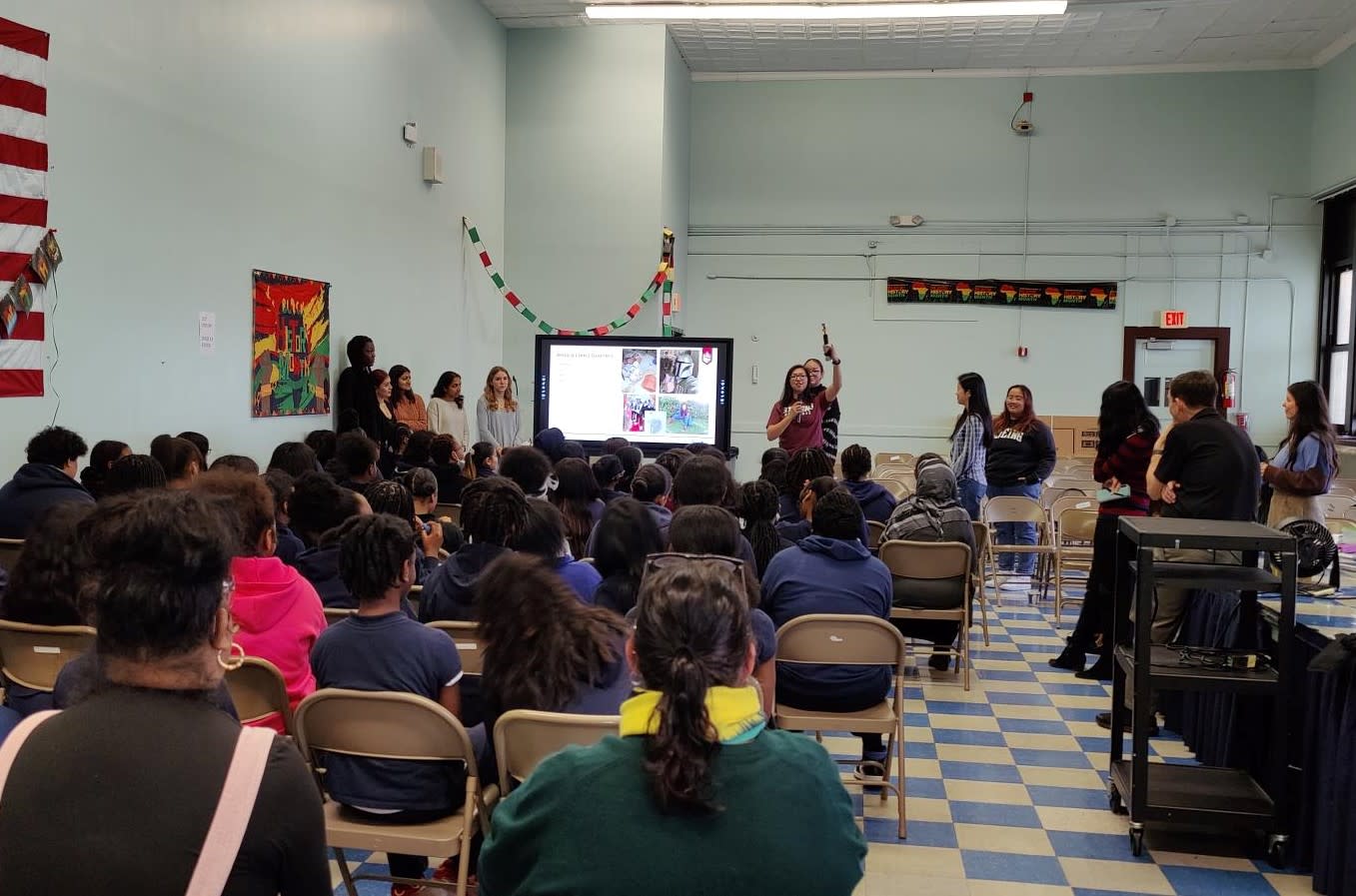 Primary school students sit in a classroom watching Stevens faculty give a demonstration