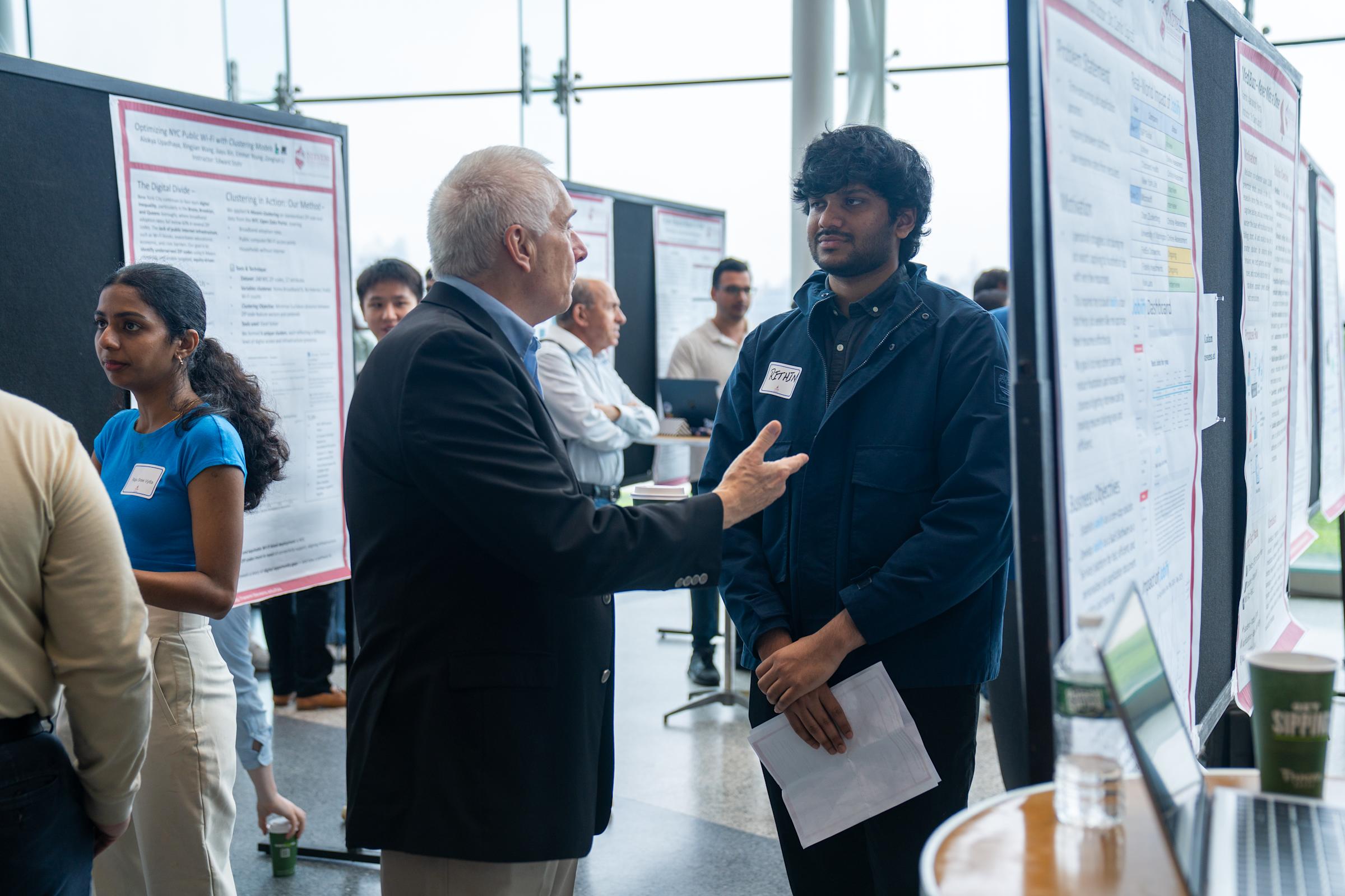 Professor Asakiewicz speaking with student