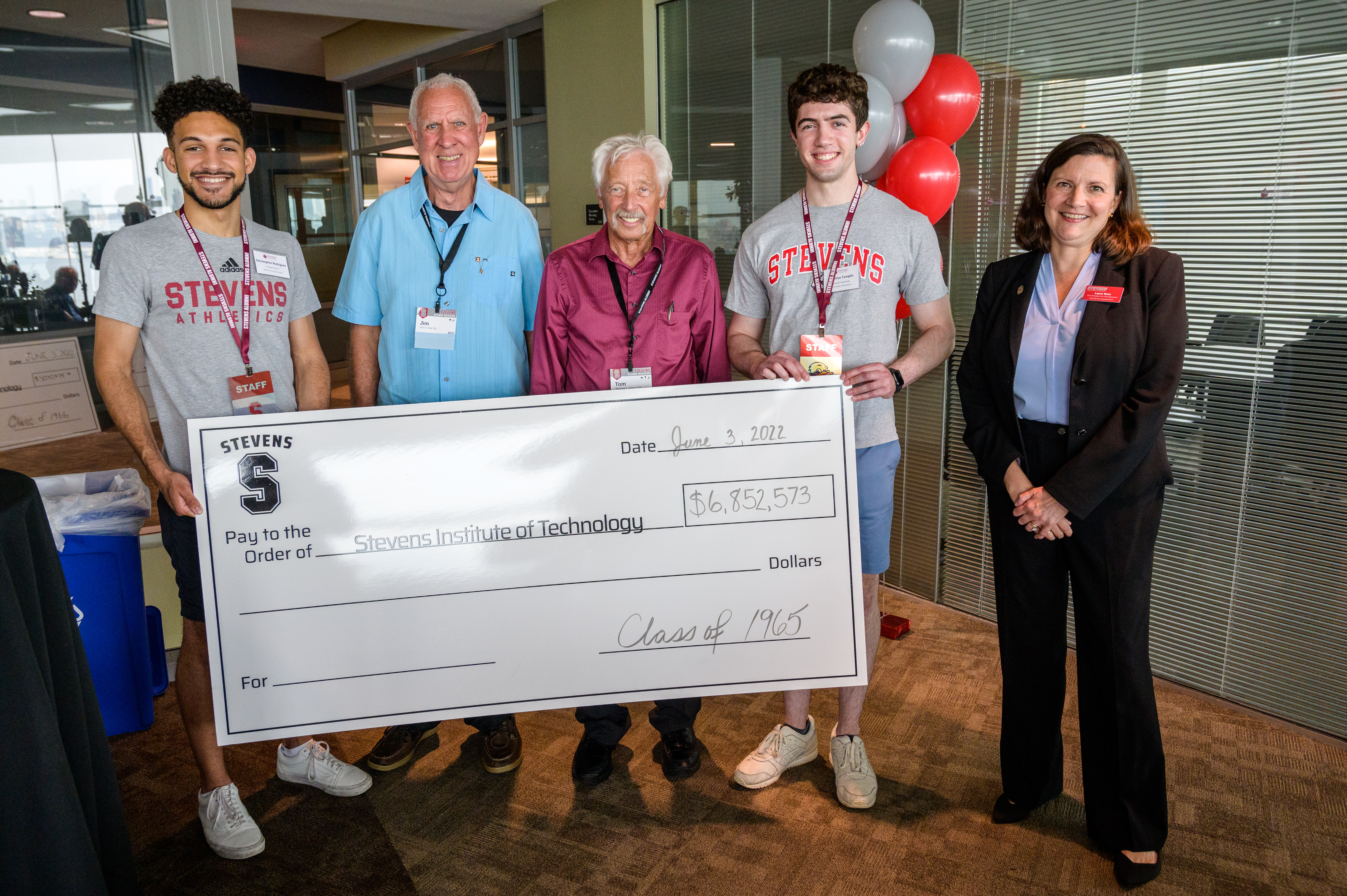 Members of the class of 1965 present their big check to Stevens students and Development and Alumni Engagement Vice President