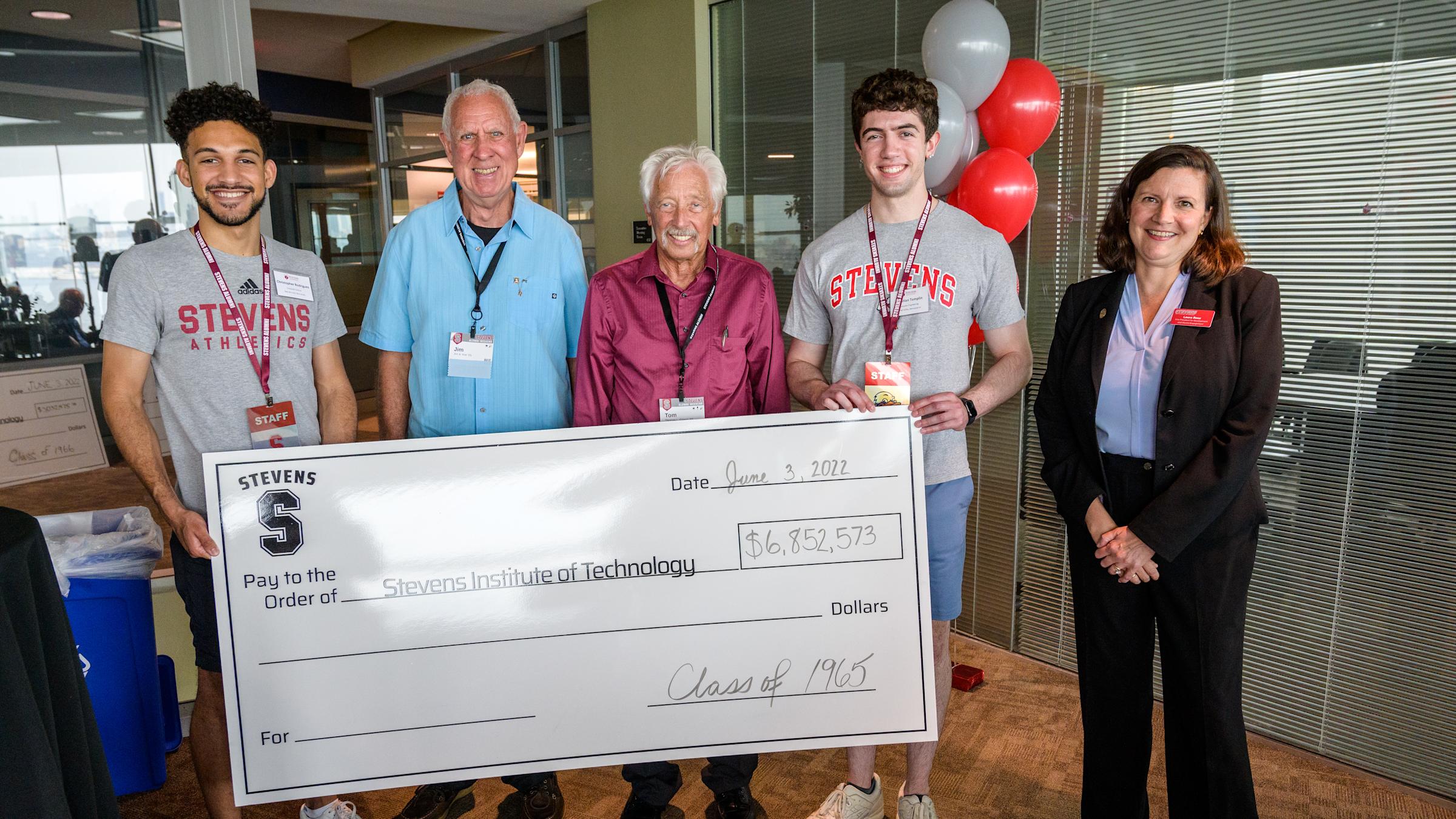 Members of the class of 1965 present their big check to Stevens students and Development and Alumni Engagement Vice President