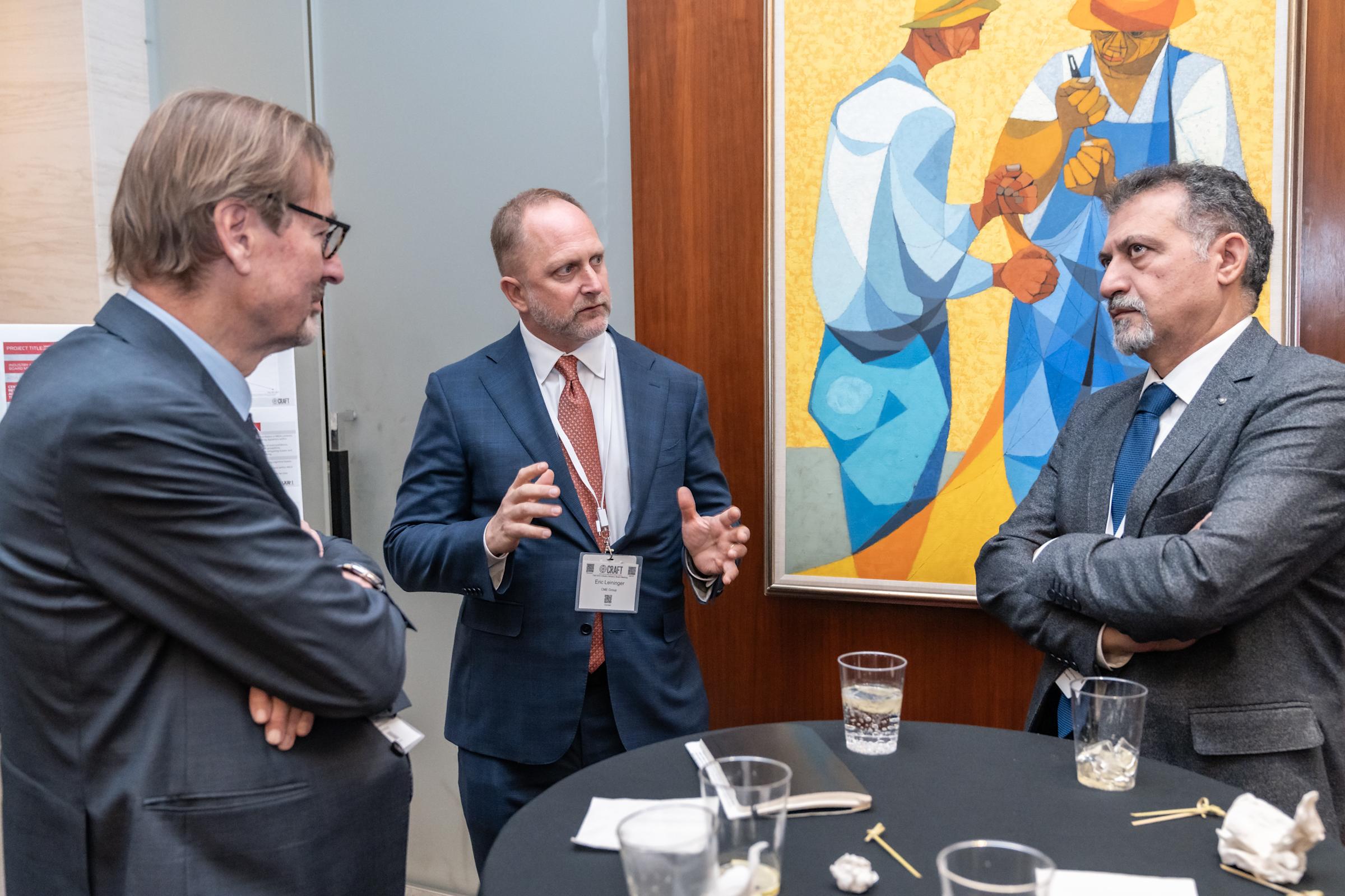 Three gentlemen speak during the CRAFT Advisory Board Meeting cocktail reception.