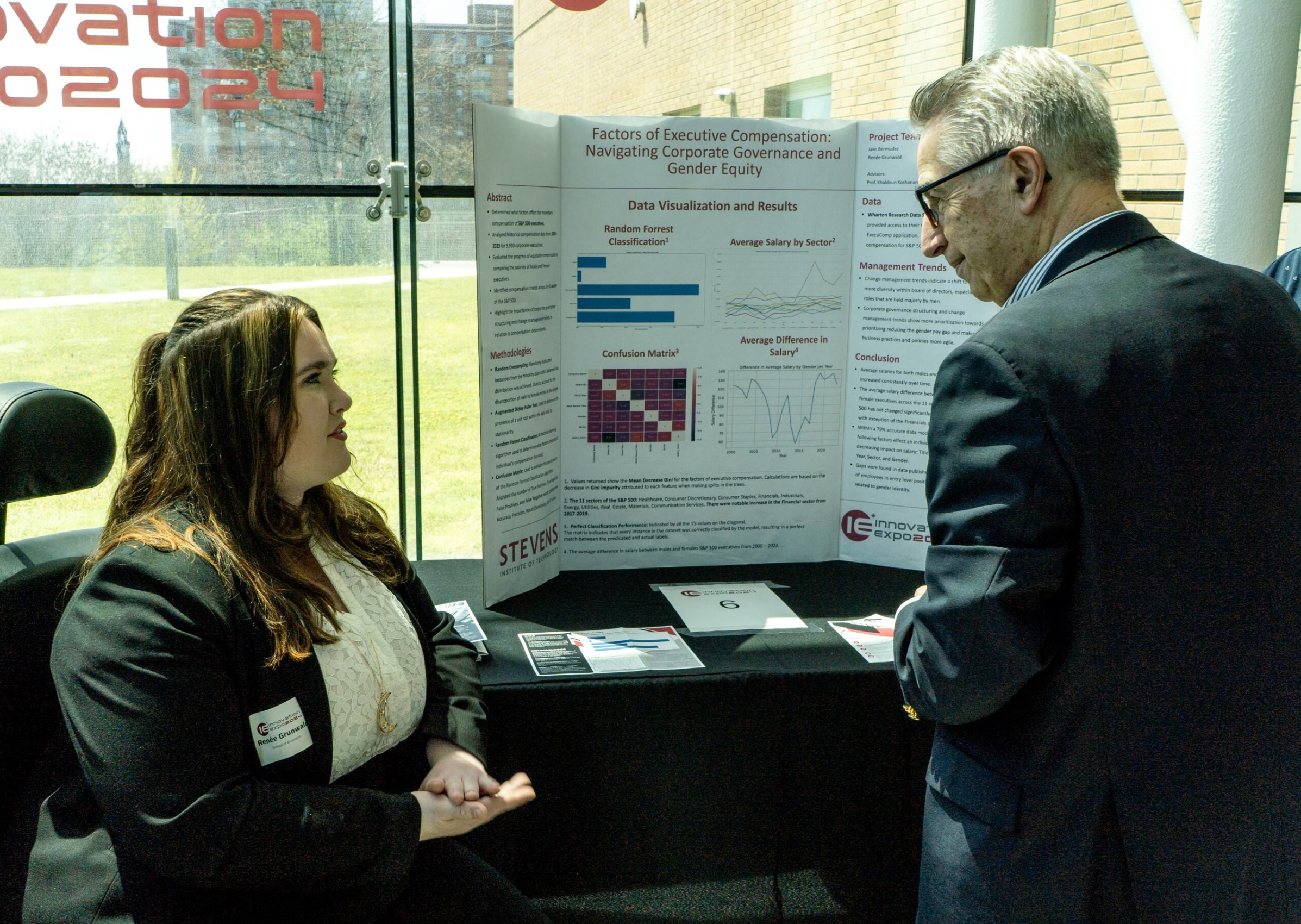 Dean Gregory Prastacos talks with a member of the project team.