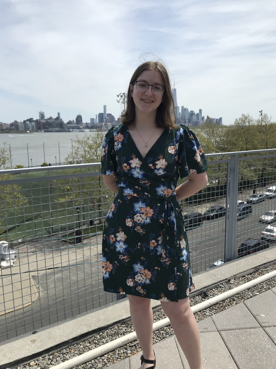 Jenna Pralat standing on the Babbio patio in front of the NYC skyline