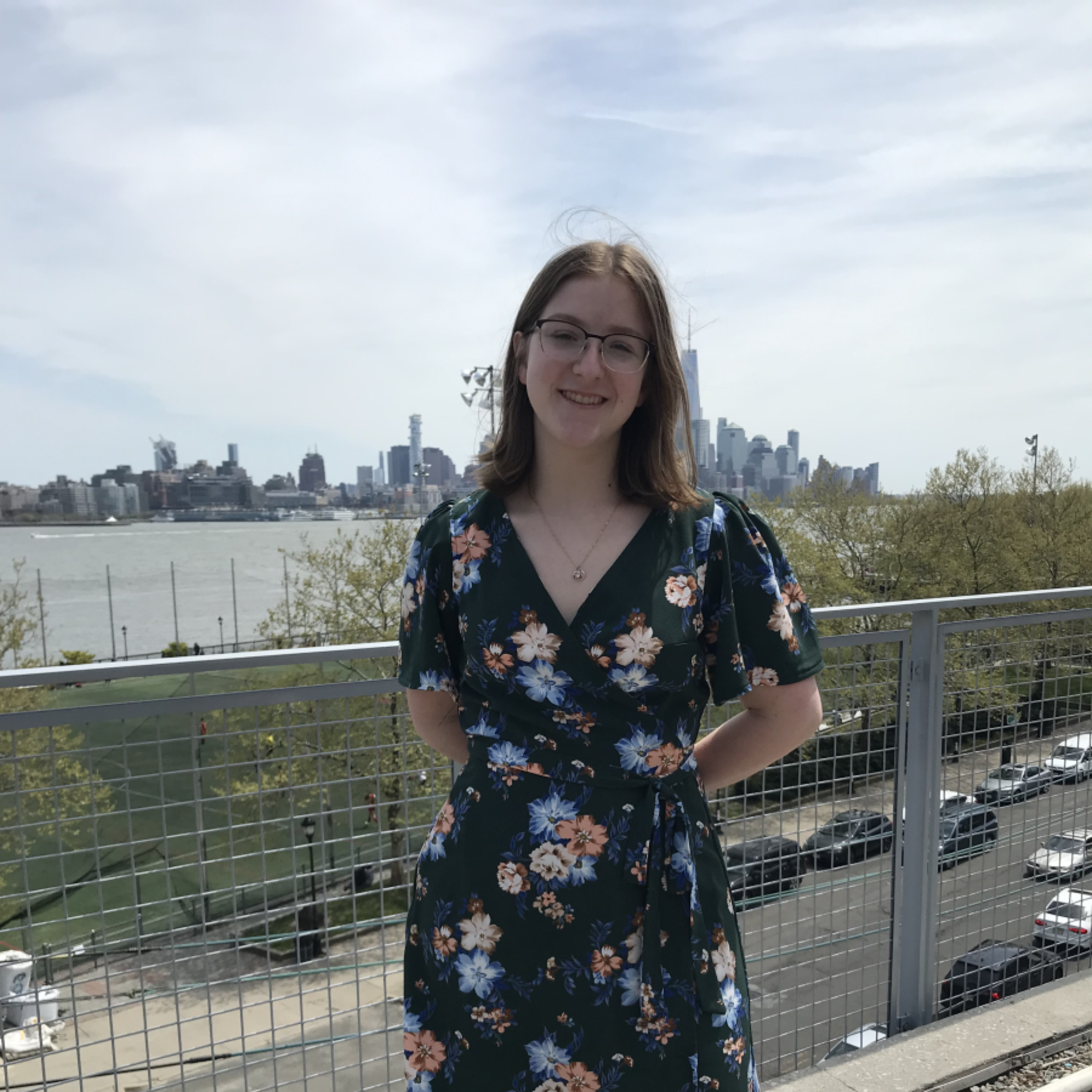 Jenna Pralat standing on the Babbio patio in front of the NYC skyline
