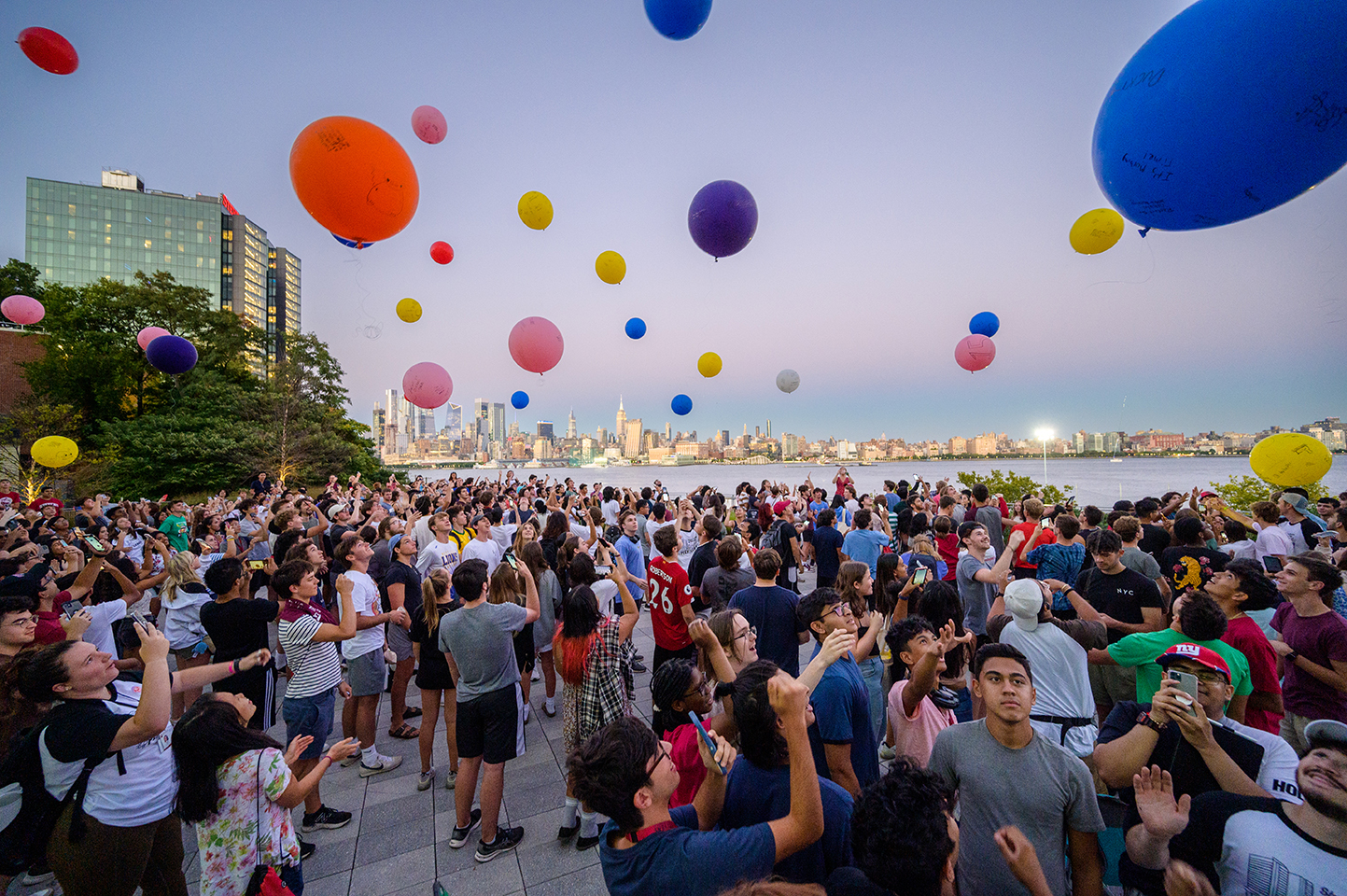 Students on campus releasing balloons into the sky