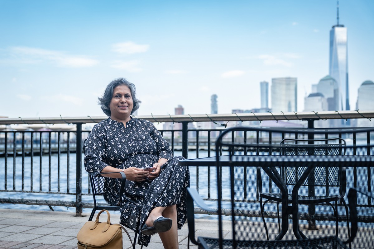 Anagha Yearned sitting on a bench in front of the World Trade Center