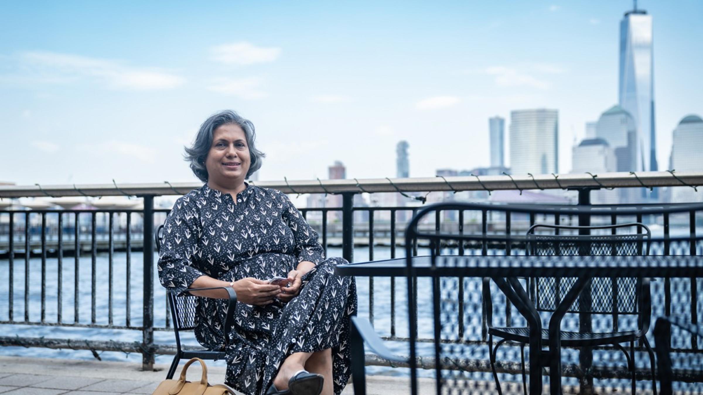 Anagha Yearned sitting on a bench in front of the World Trade Center