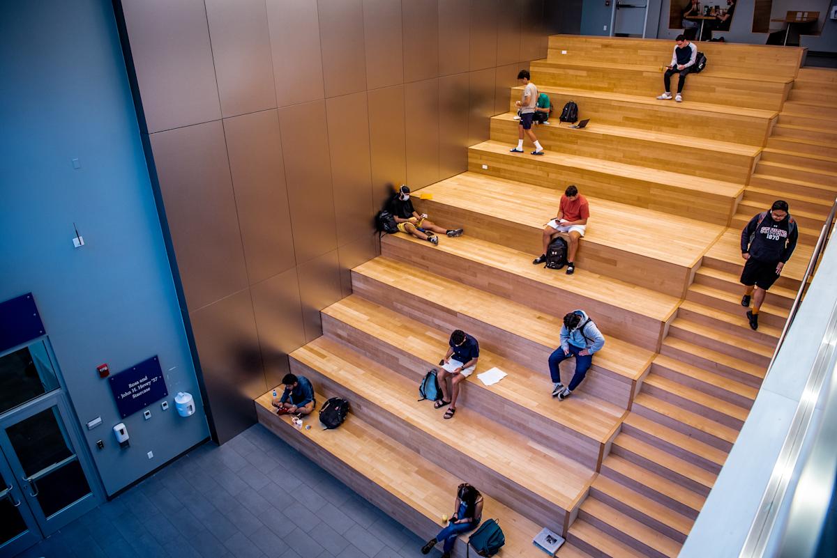 Students study on the inside steps of the Gateway Academic Center