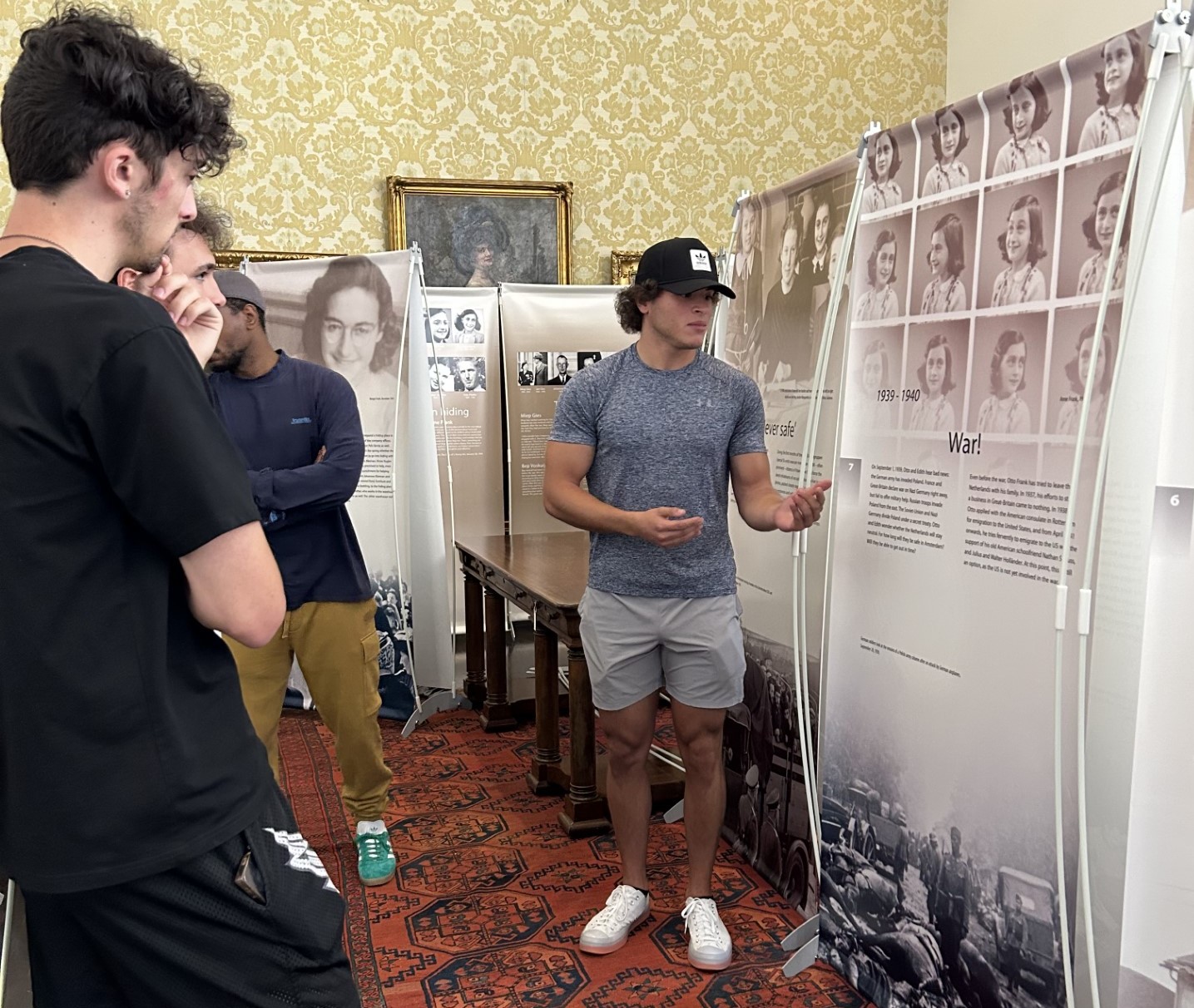 Daniel Yassa '24 gives a tour of the Anne Frank Exhibit in the S.C. Williams Library.