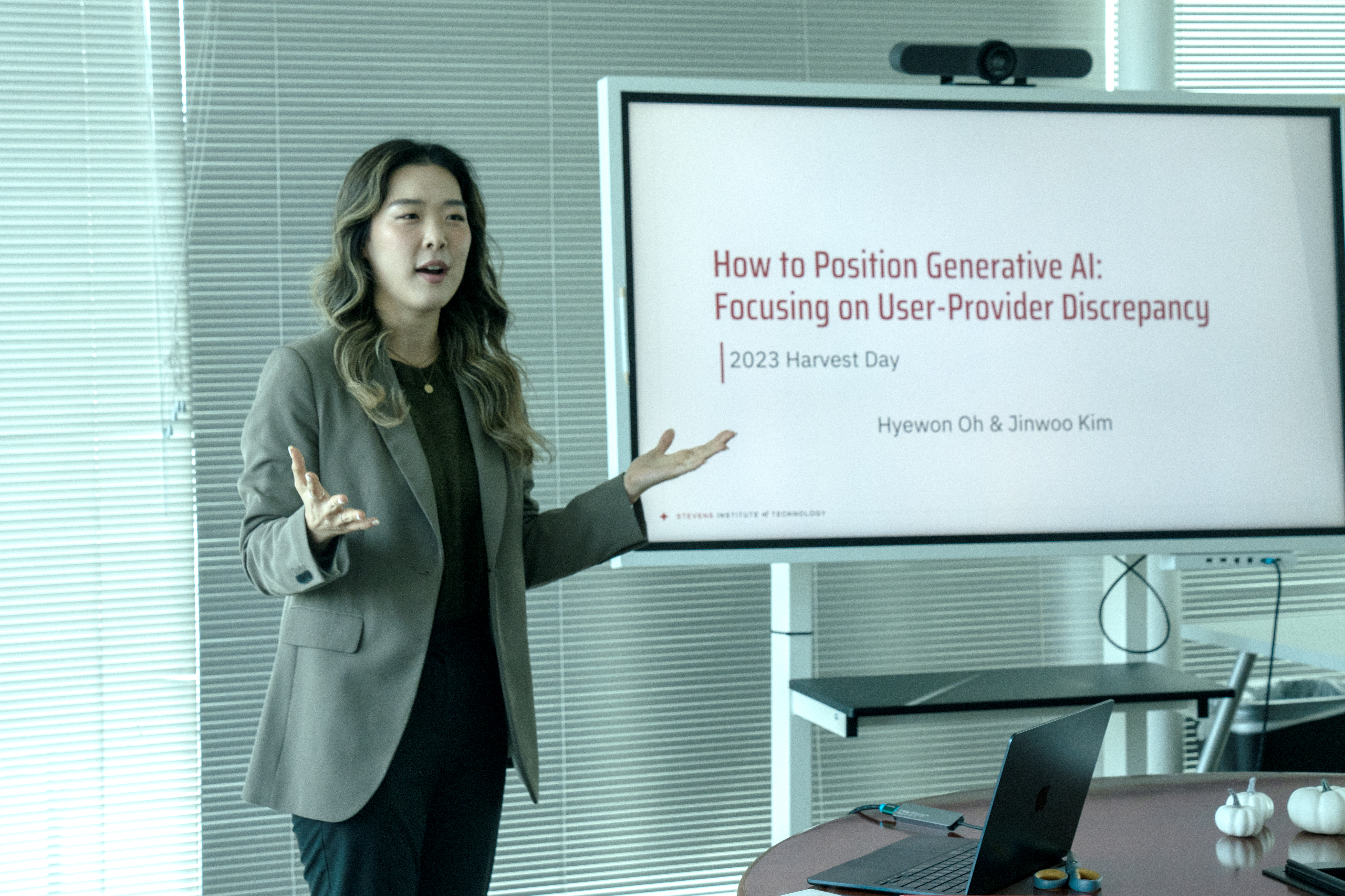 Hyewon Oh stands to the left of a smart board that reads How to Position Generative AI: Focusing on User-Provider Discrpepancy