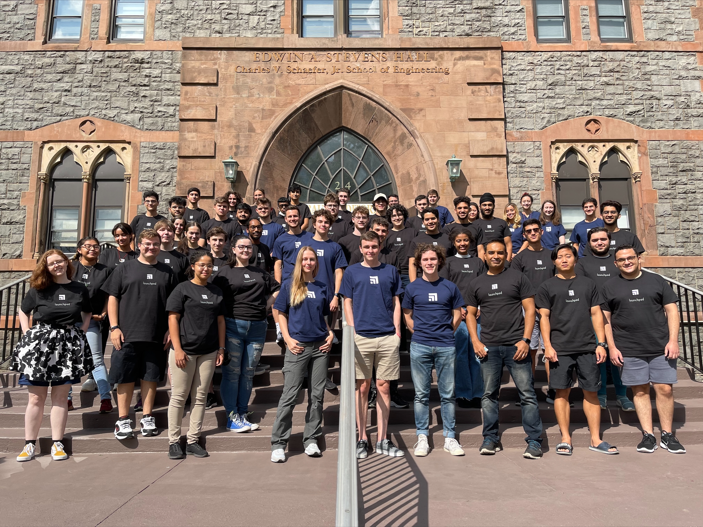 Group of Launchpad students and mentor pose on the steps of the Edwin A. Stevens Building