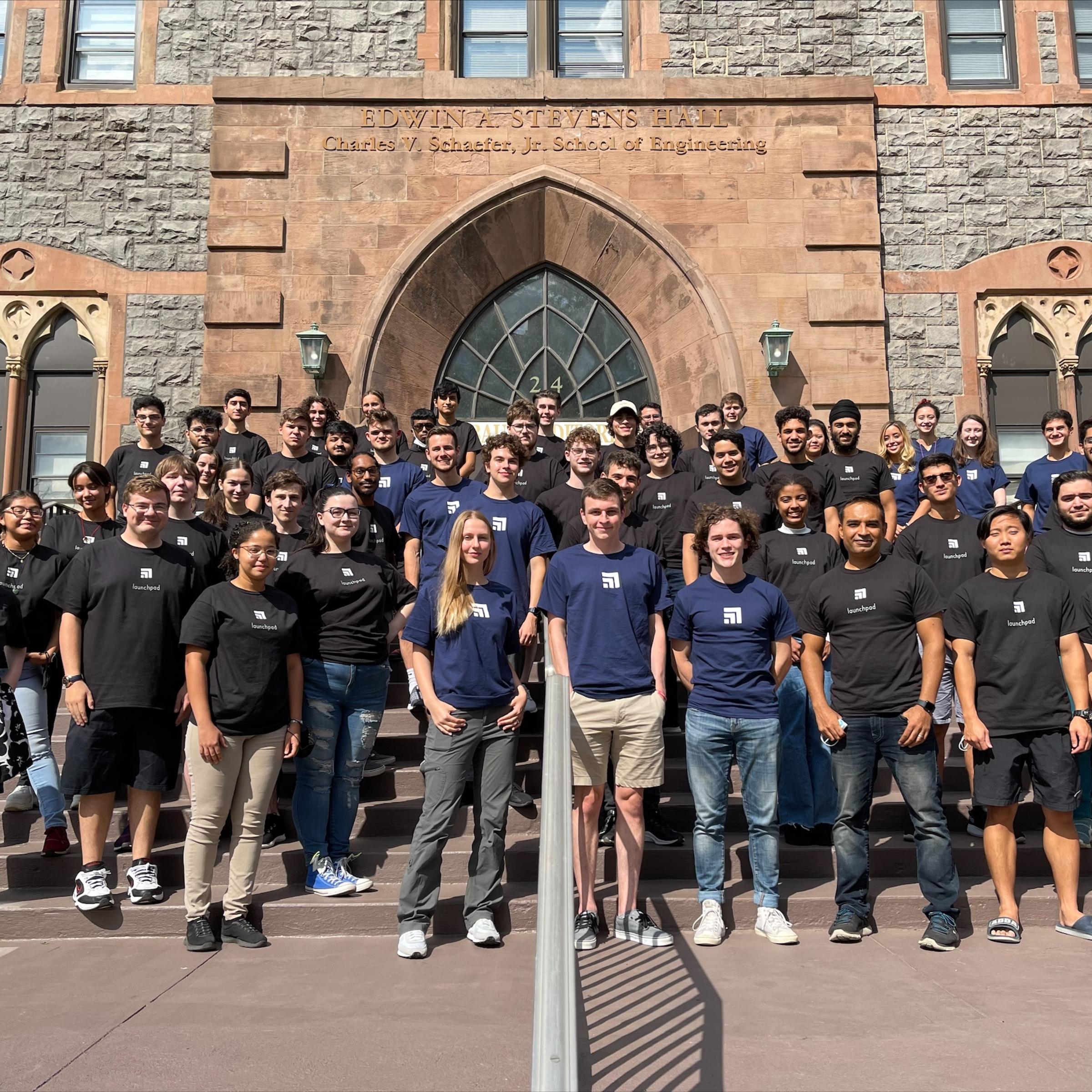 Group of Launchpad students and mentor pose on the steps of the Edwin A. Stevens Building
