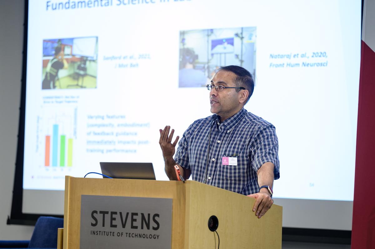 Raviraj Nataraj stands at a Stevens branded podium and discusses his research.