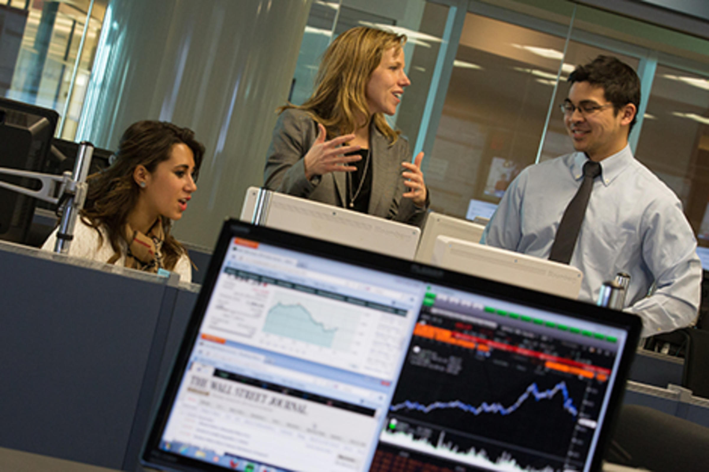 Faculty members talking in the Center for Decision Technologies
