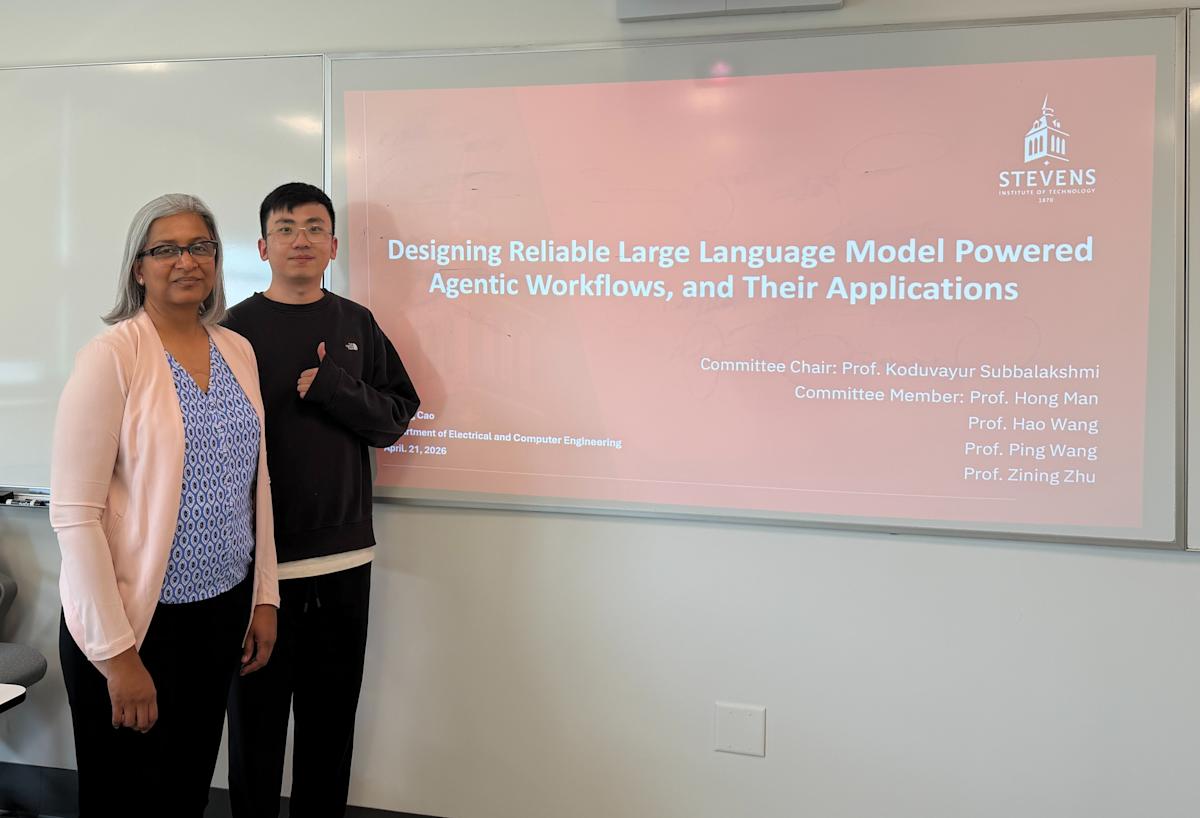 A photograph of K.P. “Suba” Subbalakshmi and her Ph.D. student Yupeng Cao standing in front of his Ph.D. defense presentation slide that reads "Designing Large Language Model Powered Agentic Workflows, and Their Applications."