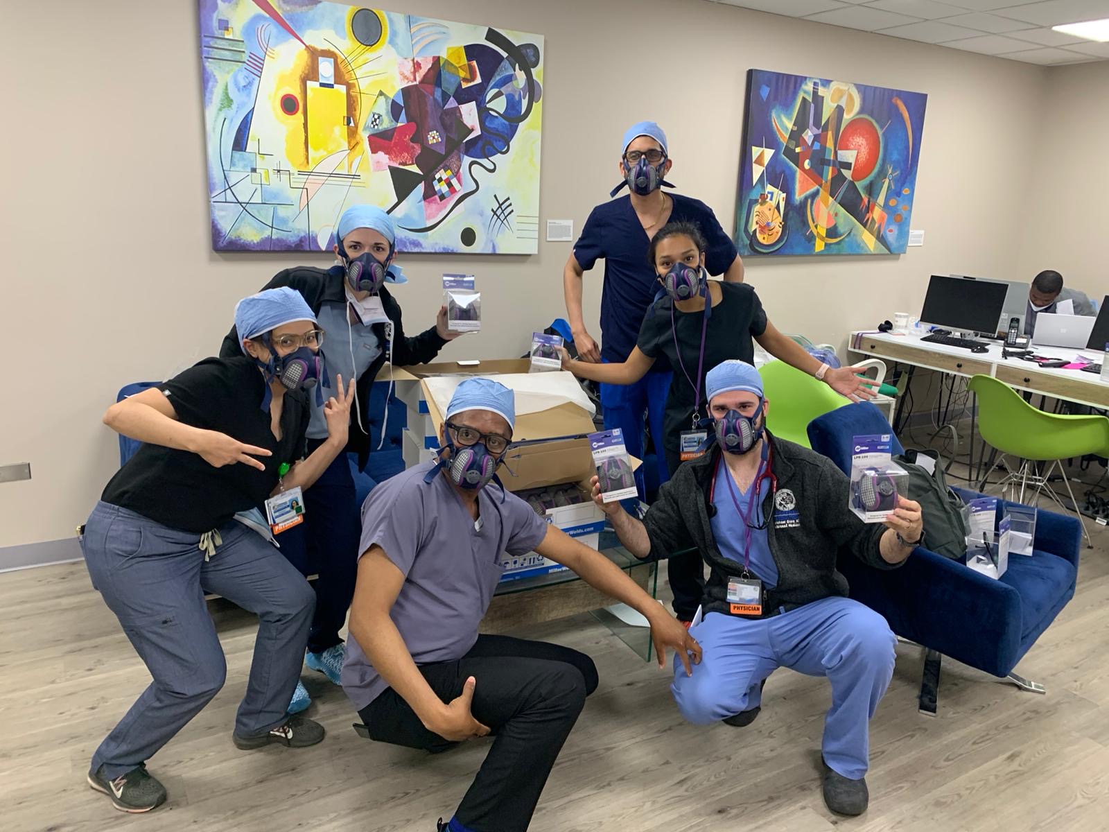 A group of doctors poses for the camera comically.